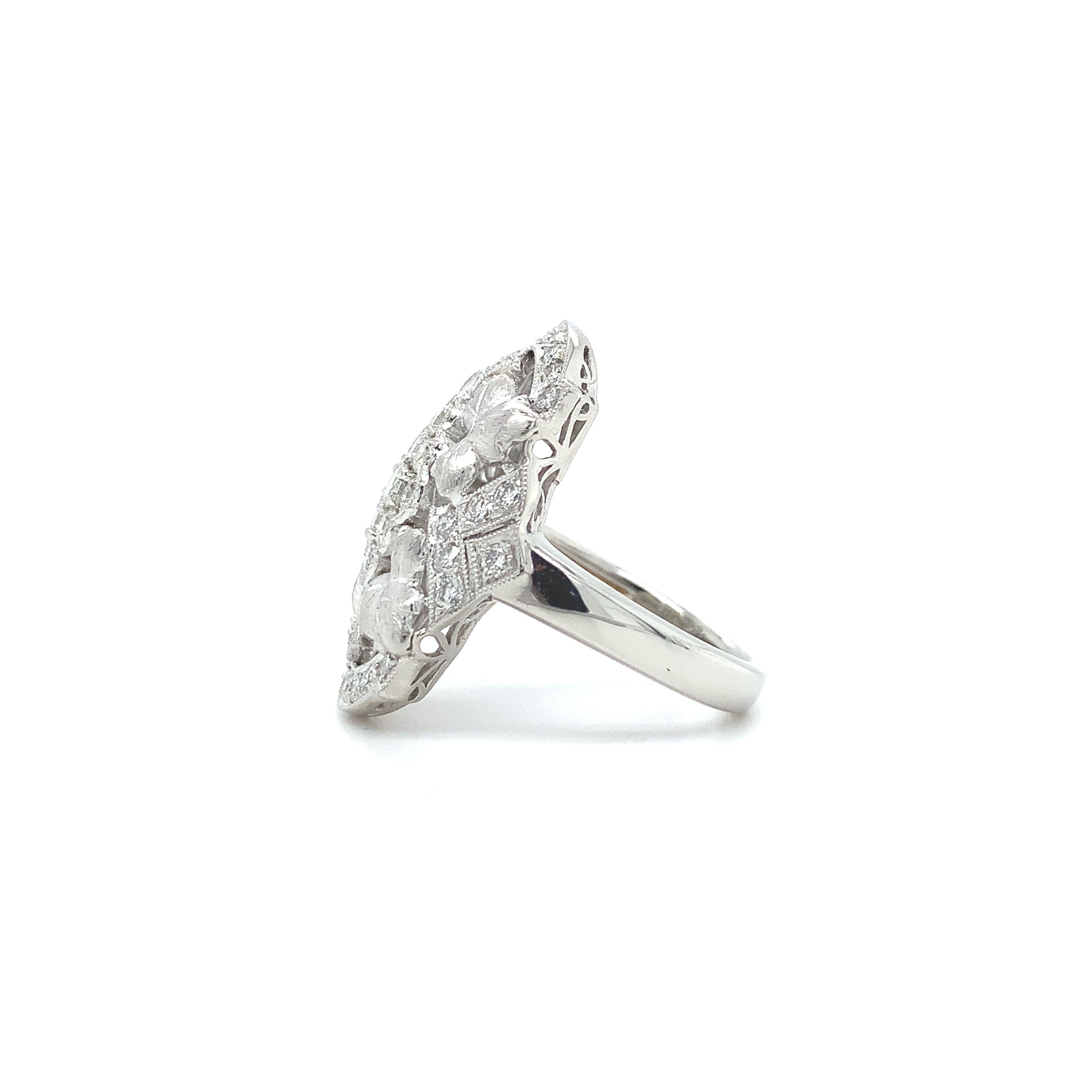 Large platinum 1.10ct tw diamond ring with 4 brushed leaves. There are 39 round brilliant cut diamonds weighing 1.10 carats total. The diamonds are high quality VS2-SI1 and G-H color. The ring fits a size 6 3/4 finger and weighs a heavy 8.19dwt. It