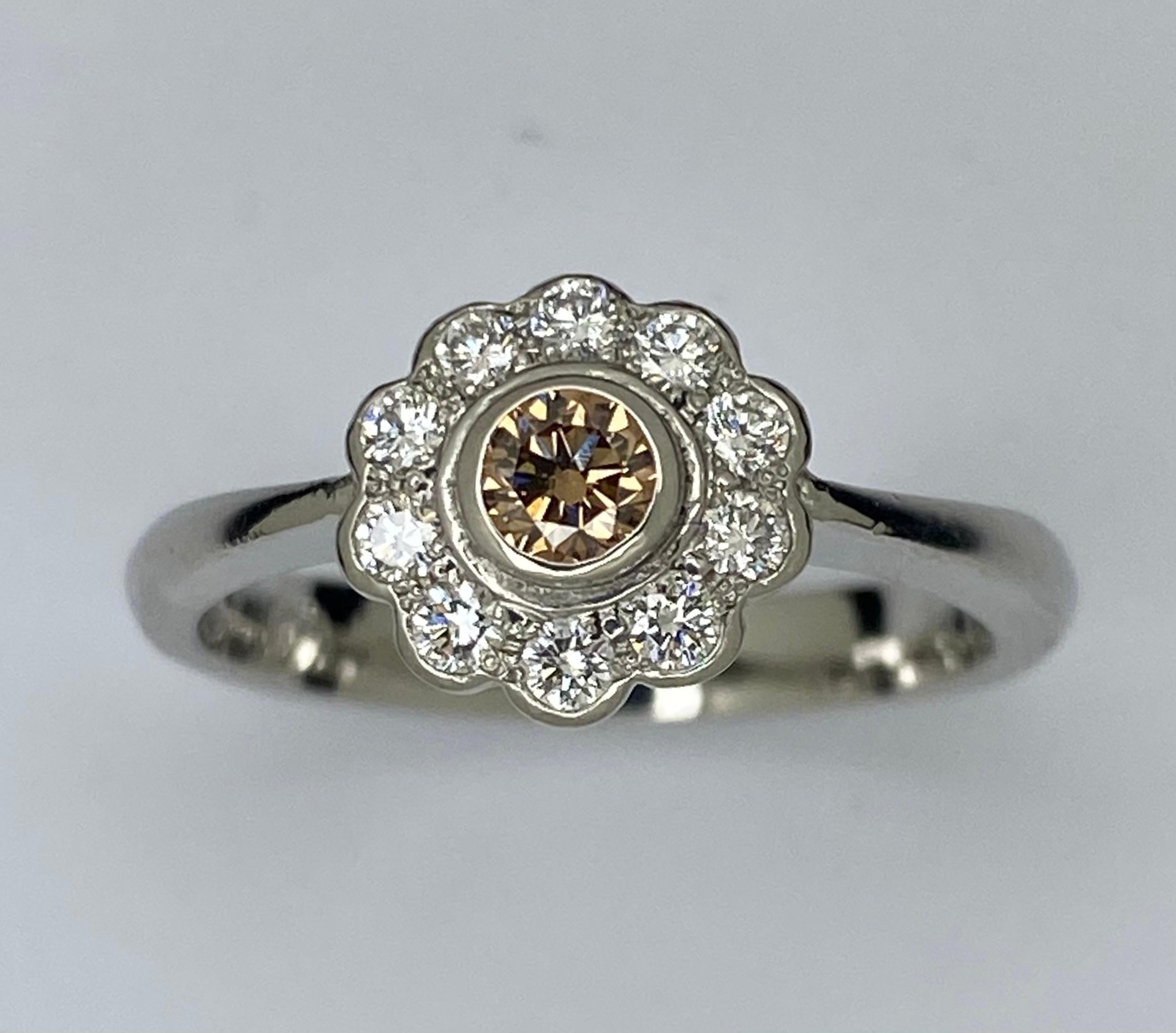 Platinum Cognac Diamond Cluster Ring

Daisy cluster design with a showcase of cognac diamond surrounding with 10 colourless diamond forming a cluster head. Band stamped 950, round shaped kangaroo head and maker stamp

Total diamond weight: 0.37