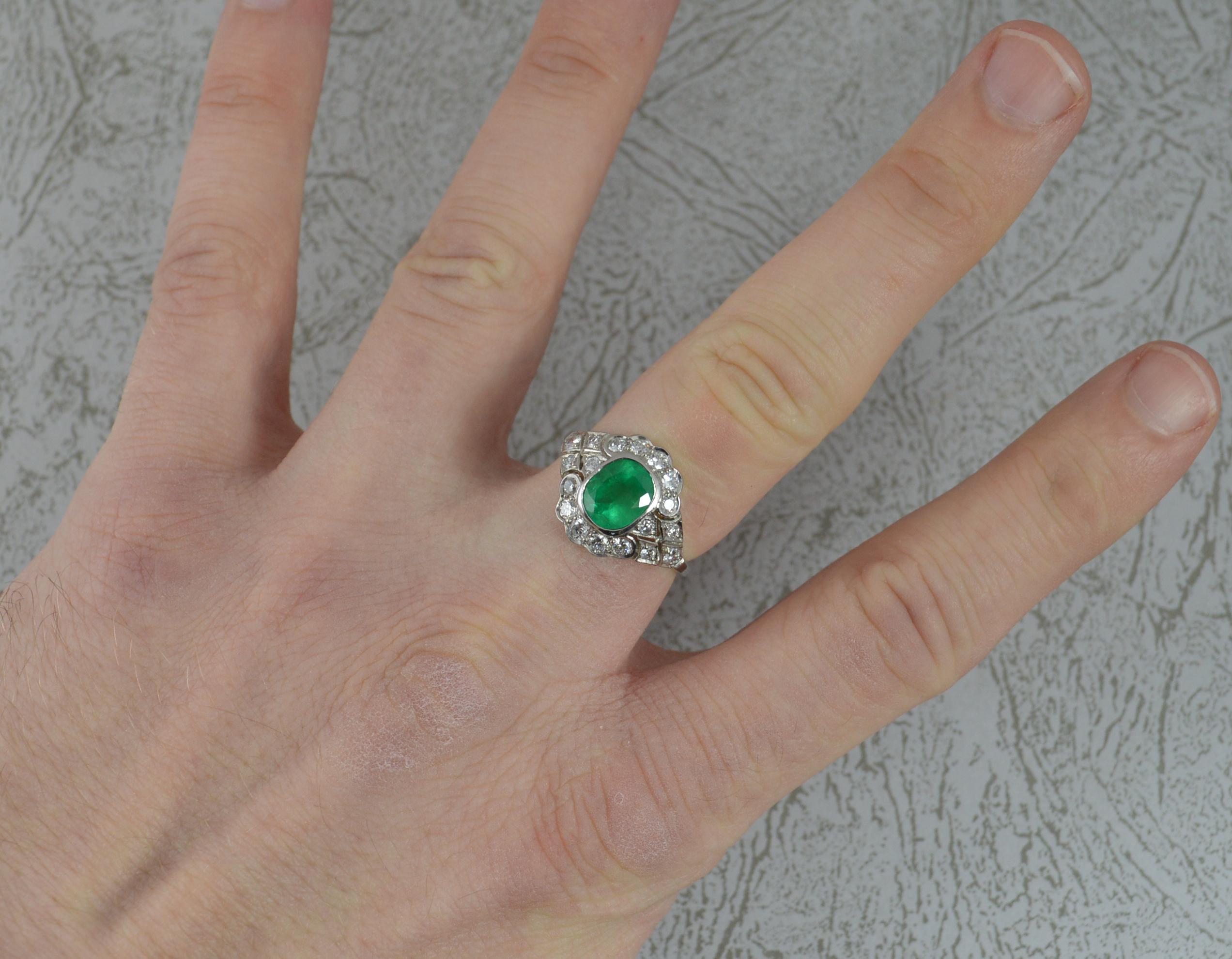 A stunning natural Emerald and Diamond ring.
Modelled in 950 grade platinum.
Designed with a cushion oval emerald, believed to be of Colombian origin in bezel setting. Surrounding are 18 natural Vs clarity diamonds in grain settings with pierced
