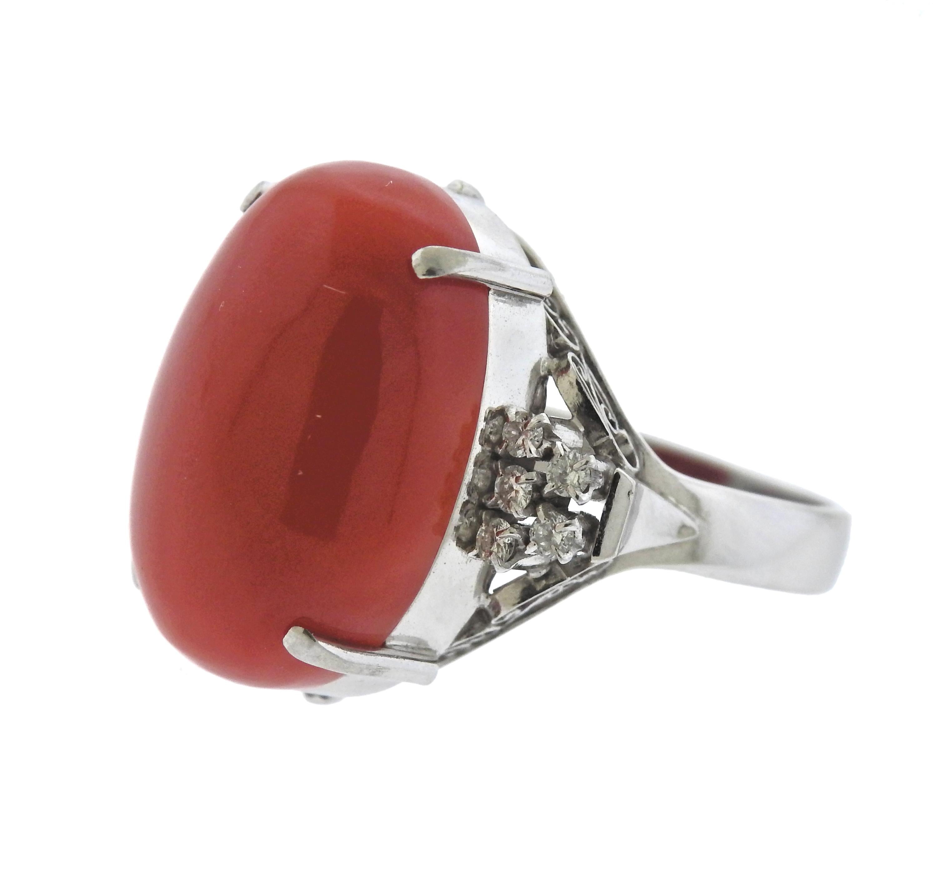 Platinum cocktail ring, set with oval 19.8mm x 13.4mm x 7mm coral gemstone, surrounded with 0.20ctw in H/VS diamonds. Ring size - 6 3/4, ring top - 20mm x 20mm, weighs 11.6 grams. Marked:  pt900, 0.20.