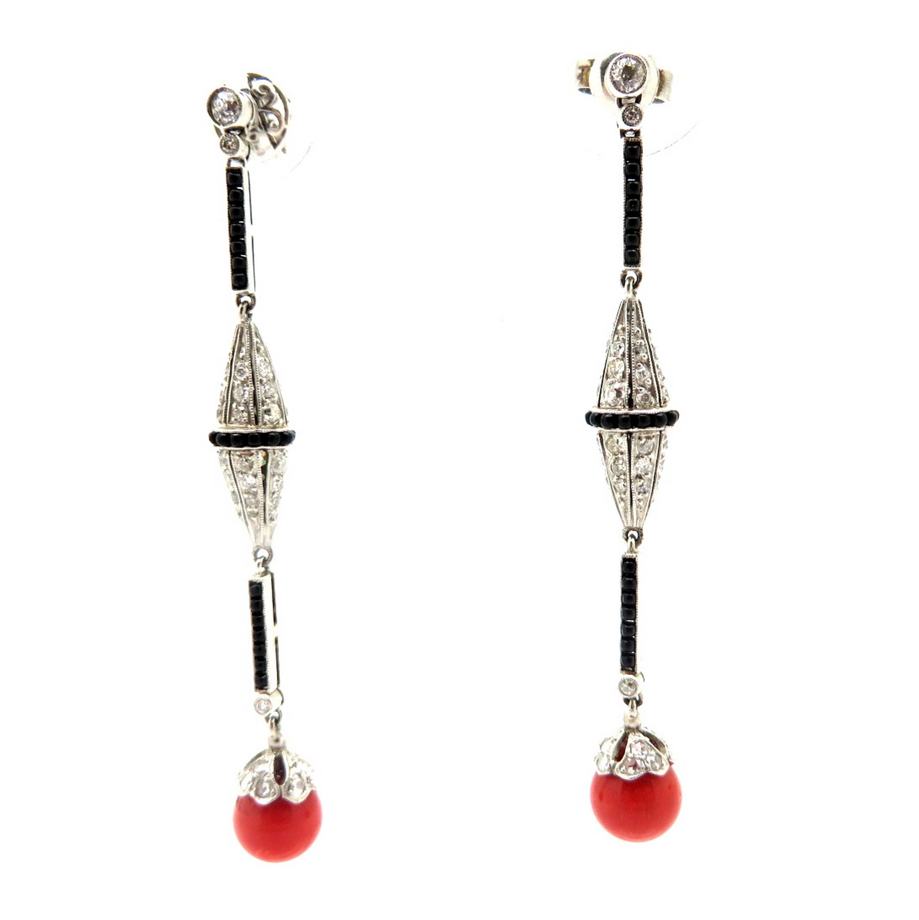 Platinum coral, onyx and Old Mine cut diamond Art Deco style chandelier dangle earrings. Showcasing numerous Old Mine cut diamonds with various measurements weighing a combined total of approximately 2.00 carats. Accented with two coral round beads