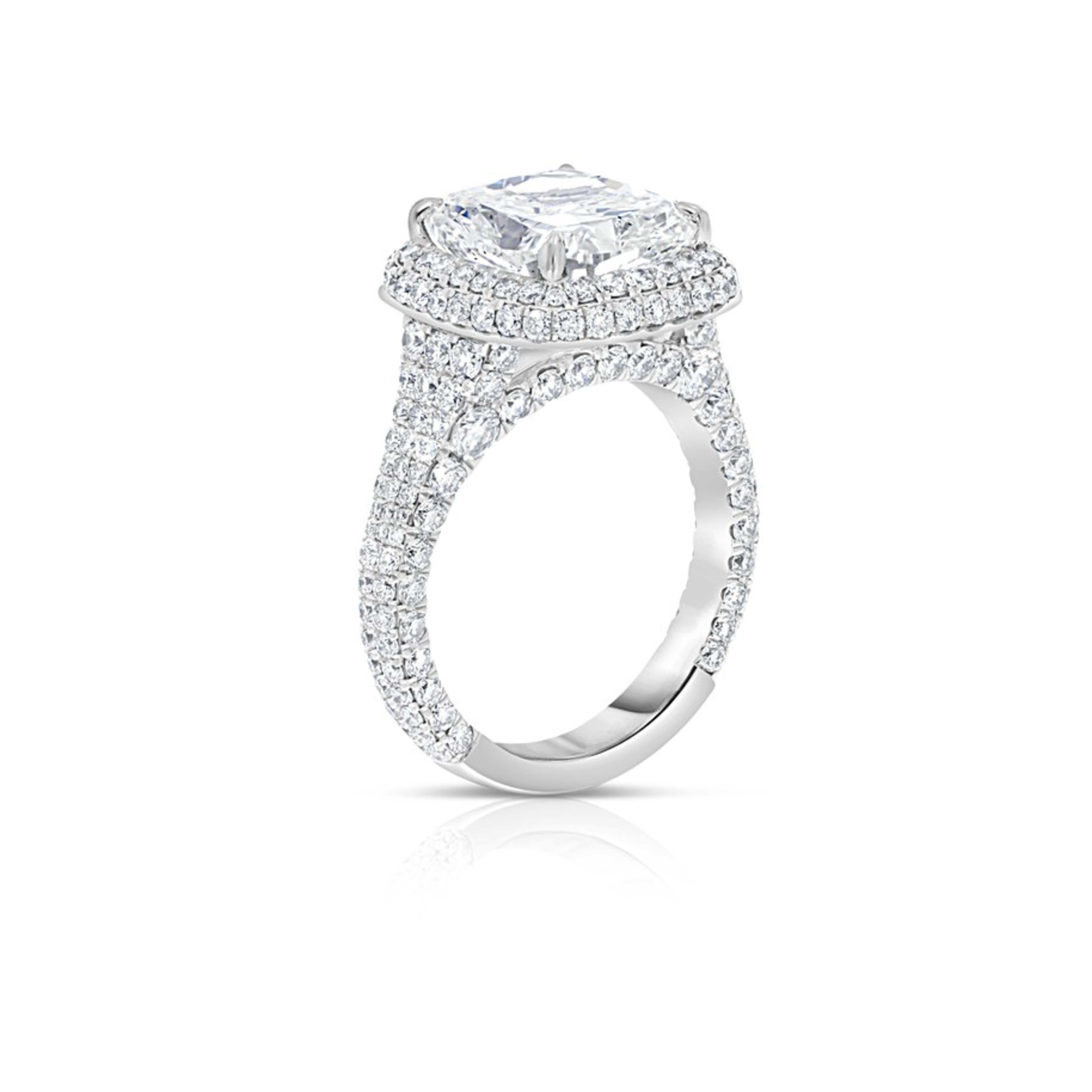 This Cushion shaped Diamond Engagement Ring displays a striking 4.64 carats cushion shaped center stone and a scintillating halo of 208 round brilliant diamonds pave-set in Platinum throughout the design, resulting in an unrivaled display of