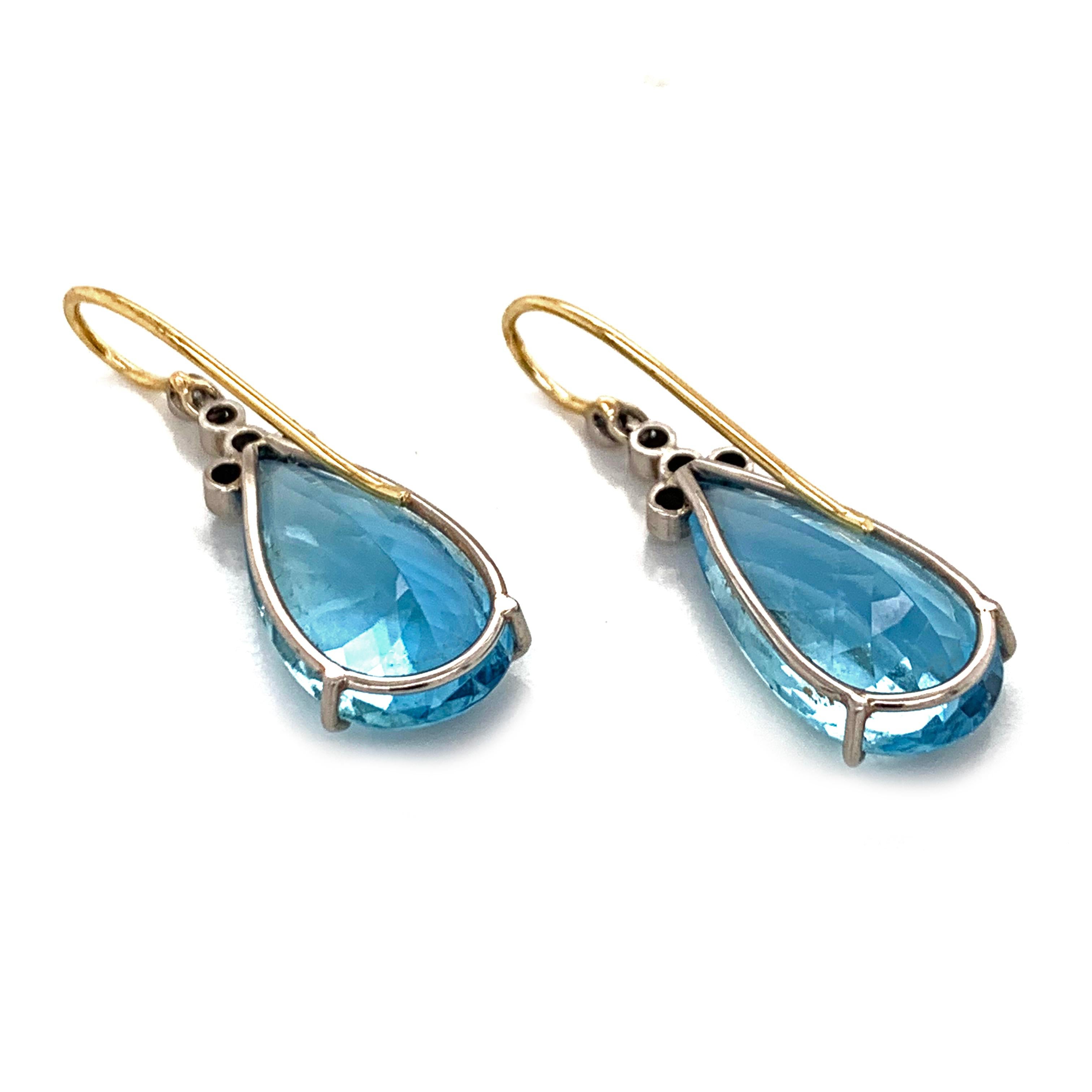 A, pair of beautiful dangle drop Aquamarine earrings. Beautifully,crafted in platinum and with a polished yellow gold  clip. With a beautiful faceted tear drop shaped Aquamarine. They are 1.2in 