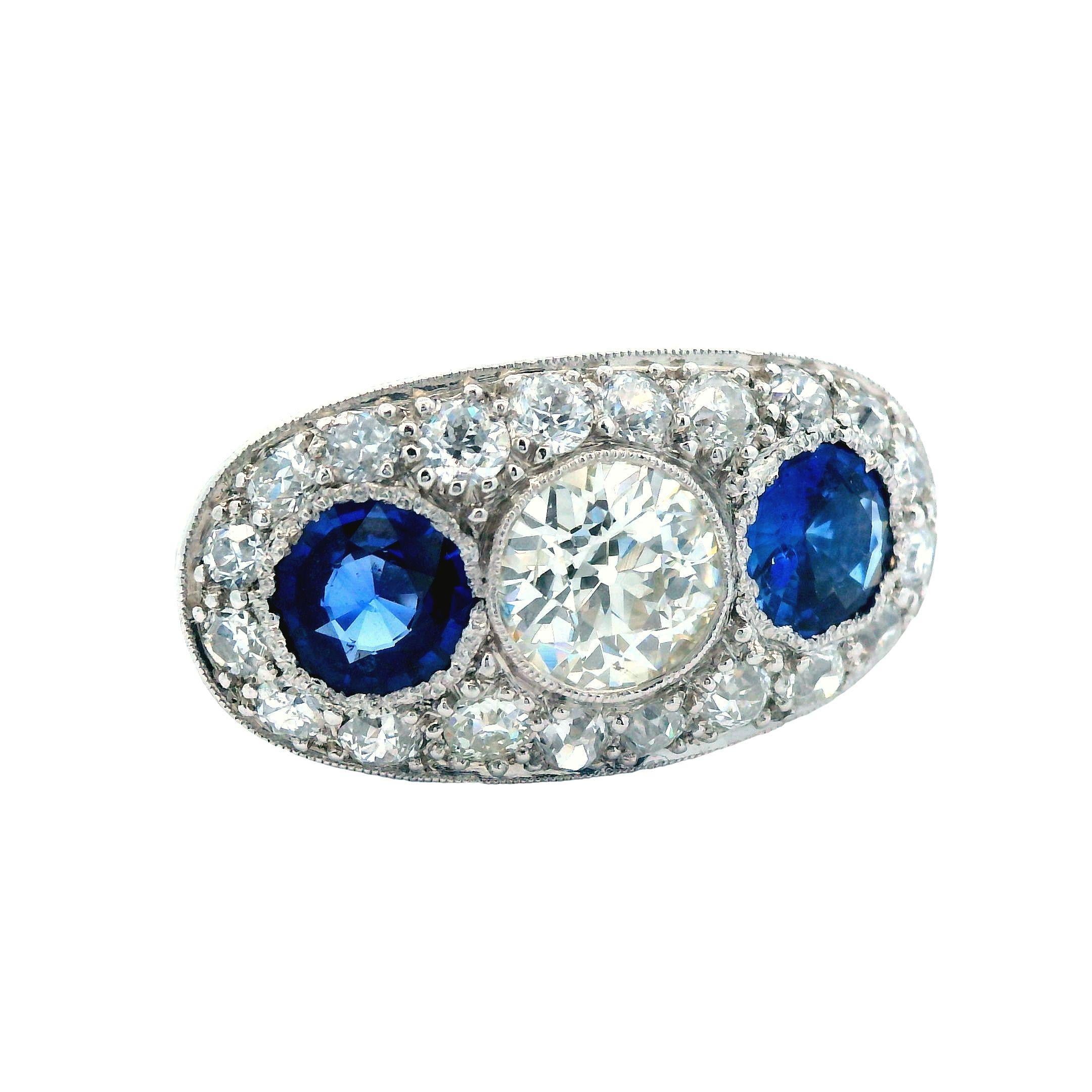 This is a classic three stone ring made in platinum with diamond and blue sapphires. This ring is very sophisticated due to the size and quality of stones used in this three stone design. The center of this ring boast a sparkly white firey .60