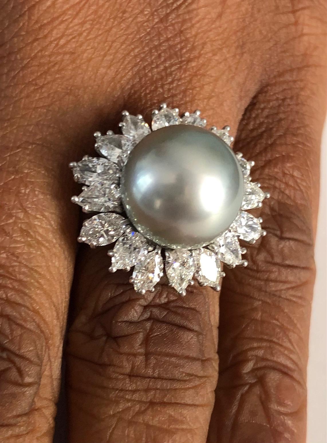 Handmade Platinum Ring, set with 16 extra fine Diamonds 3.38 carats and a High Quality Tahitian Pearls 13.4mm

We design and manufacture our jewelry in our workshop, located in New York City's diamond district.