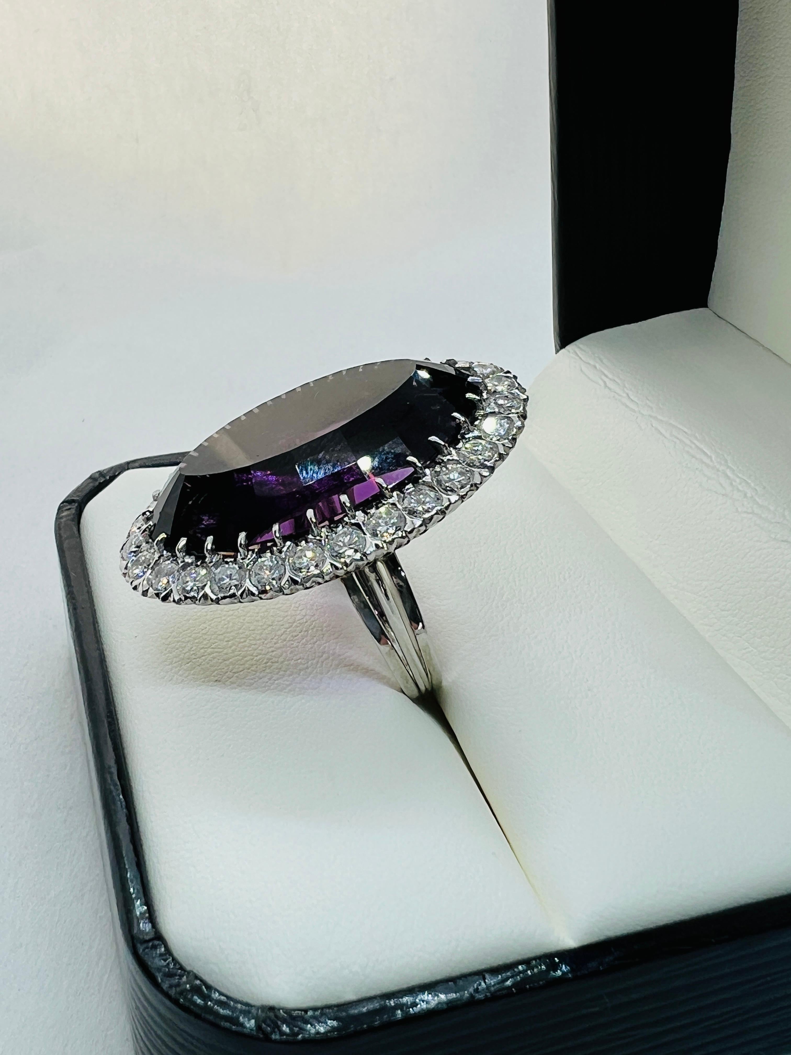 Absolutely Stunning Ladies Cocktail Ring!!! Made in Platinum, this ring features a beautiful 40 carat, oval amethyst. The amethyst is surrounded by 29 round diamonds with an estimated total weight of 3 carats. The oval measures 1.50 inches by 1.25