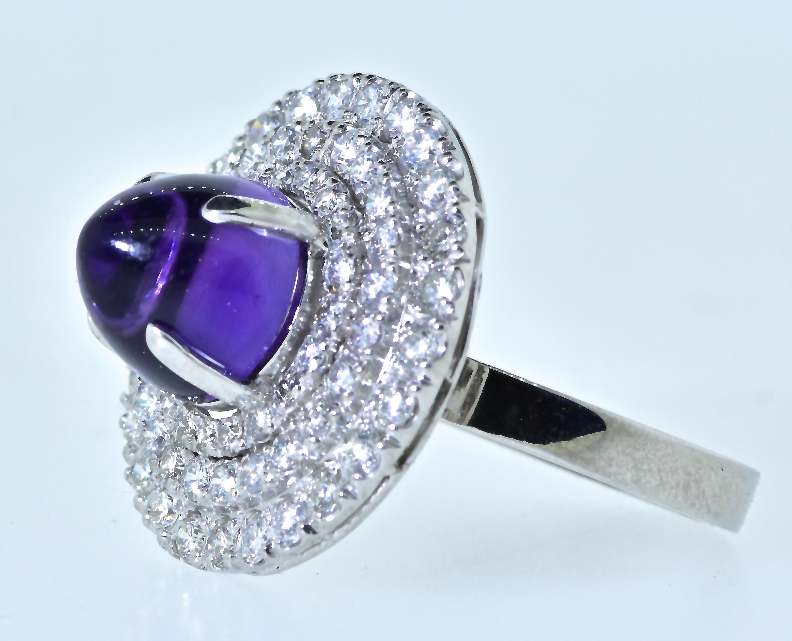The natural vivid purple amethyst is cut in a high nipple cabochon, estimated to weigh 3.63 cts., and surrounded by 67 finely matched near colorless brilliant cut diamonds estimated to weigh 1.30 cts.  This is a well made platinum.    All items sold