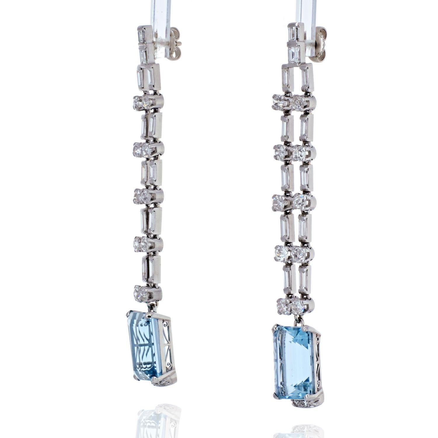 Elegant and romantic these platinum diamond and aquamarine cascade dangling fine earrings will make a beautiful addition to any outfit. Delicate baguette and brilliant cut diamonds complement the soft color of the aquamarines making these stylish
