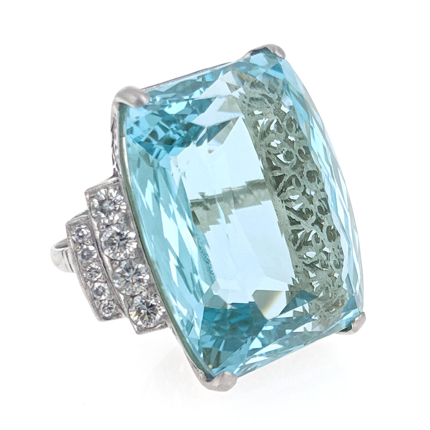 This stunning ring centers upon a mixed cut aquamarine weighing approximately 48 carats and is accented by a double line of round brilliant-cut diamonds weighing approximately 1 carat. The ring is expertly crafted in platinum with beautiful open