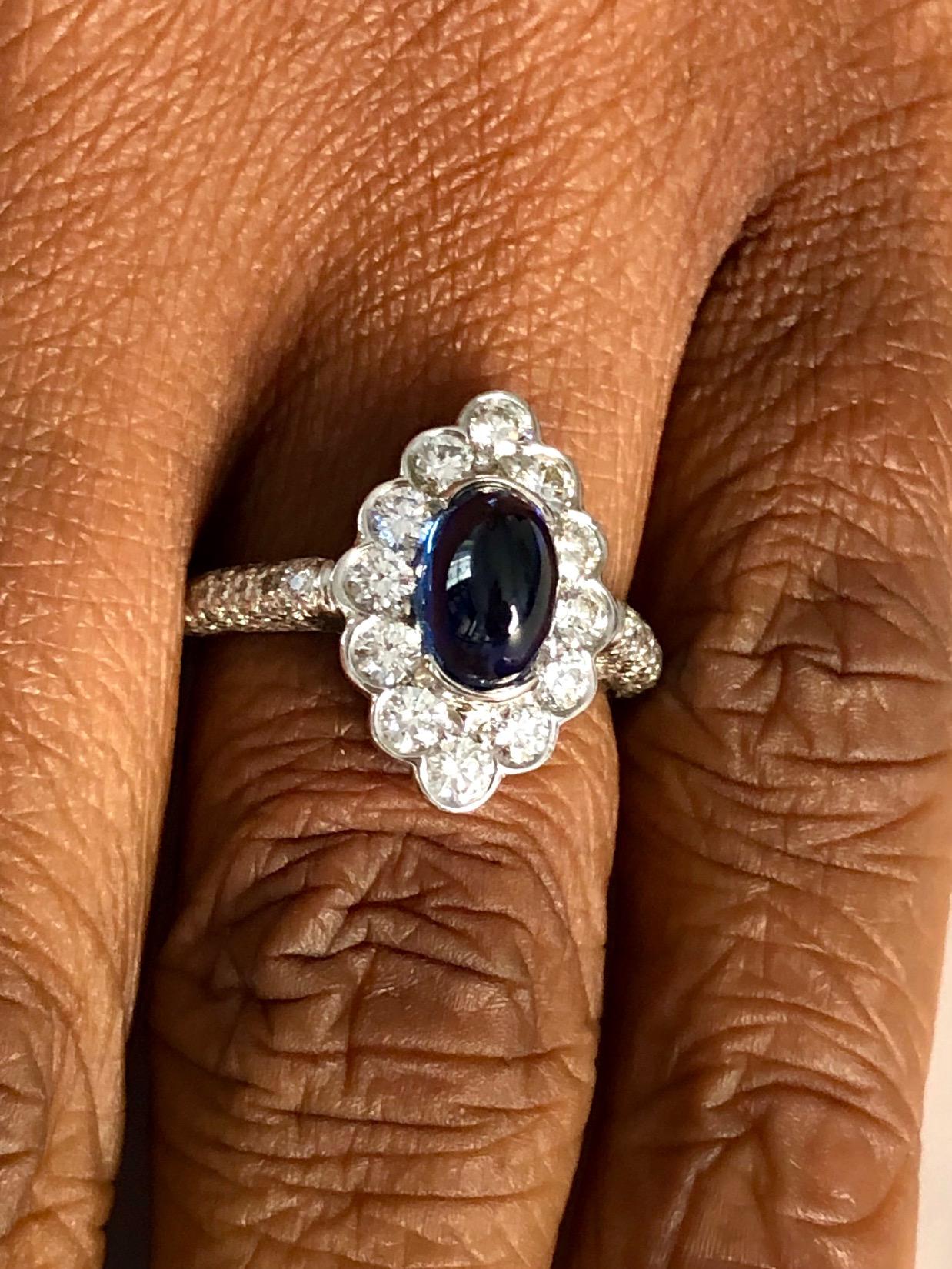 Marquise shape Ring made in Platinum, set with 96 diamonds 1.10 carats and a Cabochon Sapphire 2.41 carats.

We design and manufacture our jewelry in our workshop, located in New York City's diamond district.