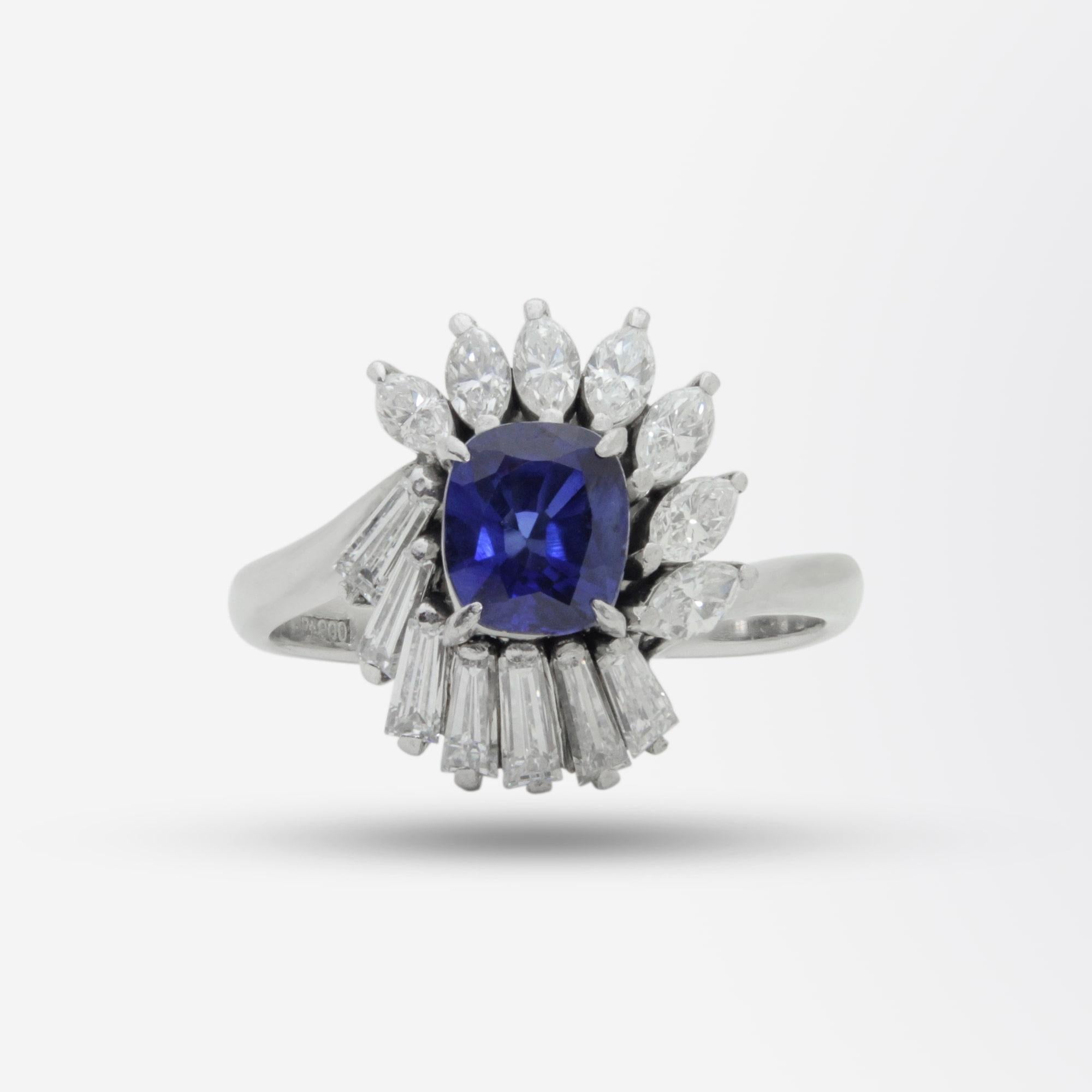 A fine ladies dress ring crafted from platinum and set with a sapphire and diamonds. The central sapphire is a 0.98 carat Cambodian cushion cut stone which has an accompanying GIA certification. Surrounding this sapphire is a mixture of tapered