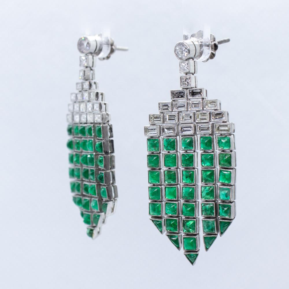 For sale is a gorgeous pair of Art Deco Platinum Diamond and Emerald chandelier earrings!
Showcasing 32 straight baguette shaped diamonds weighing approximately 2.15 carats. Diamond Grading: Color Grade: H. Clarity Grade: VS2.
The earrings feature