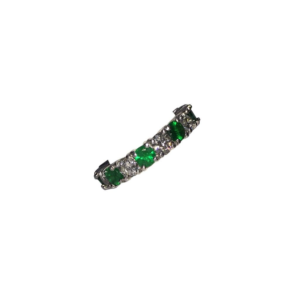 Platinum eternity ring with round diamonds and round emeralds. 9 diamonds are 2.35 carats total weight, G-H color and VS2-SI1 clarity. 9 emeralds are 3.05 carats. Ring measures 4 mm's wide and 3 mm thick. Ring is a size 6 1/2.