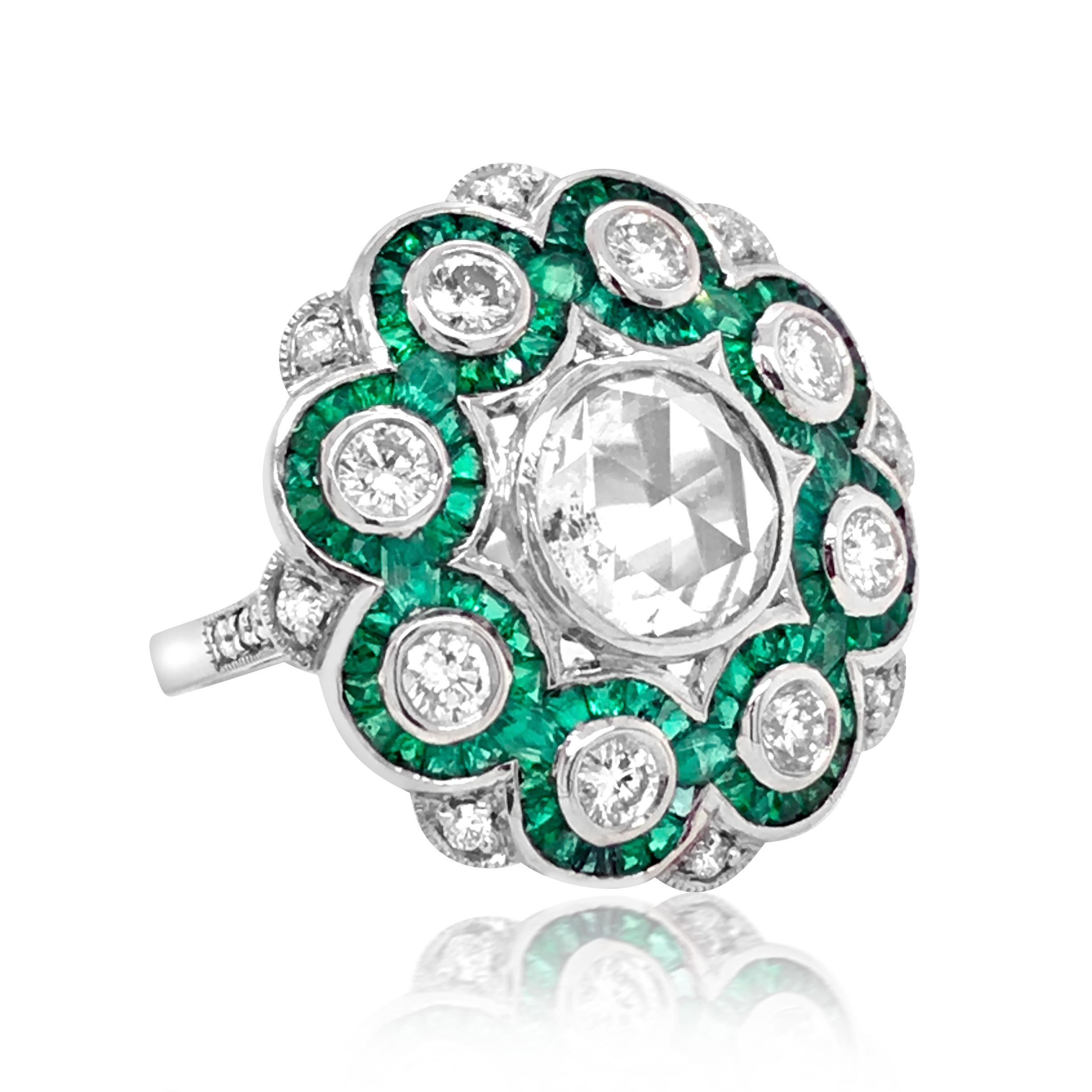 This stunning and captivating emerald and diamond ring is crafted in solid platinum, centered with a rose cut diamond graded G-H/I1, enhanced with other 20 round diamonds, majority graded G-H/SI, few VS. The total diamonds weigh approx. 1.75ct. The