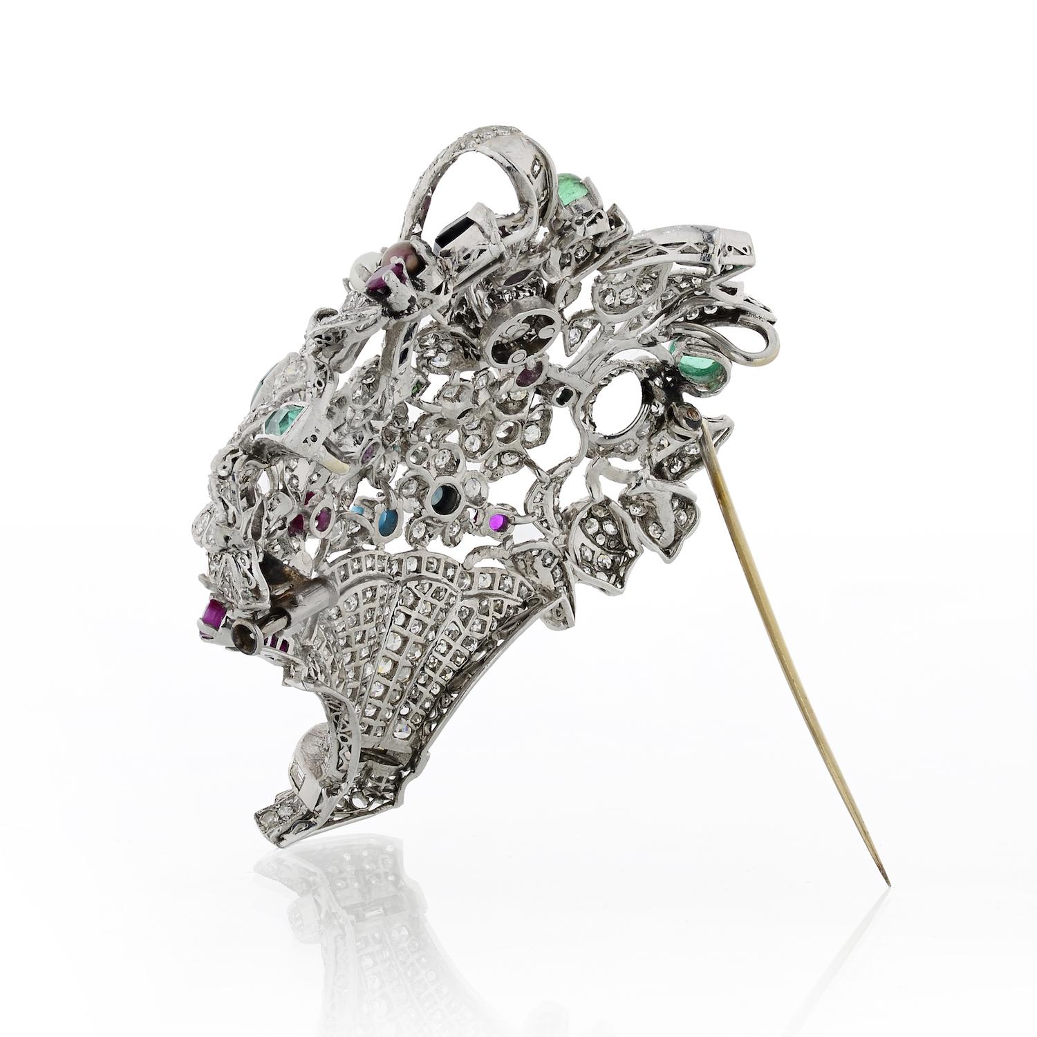 Platinum diamond basket brooch from the 1950's set with diamonds and gemstones. 
Diamonds weight: 4 carats approx. 
Gemstones: 2.50cts approx. 

