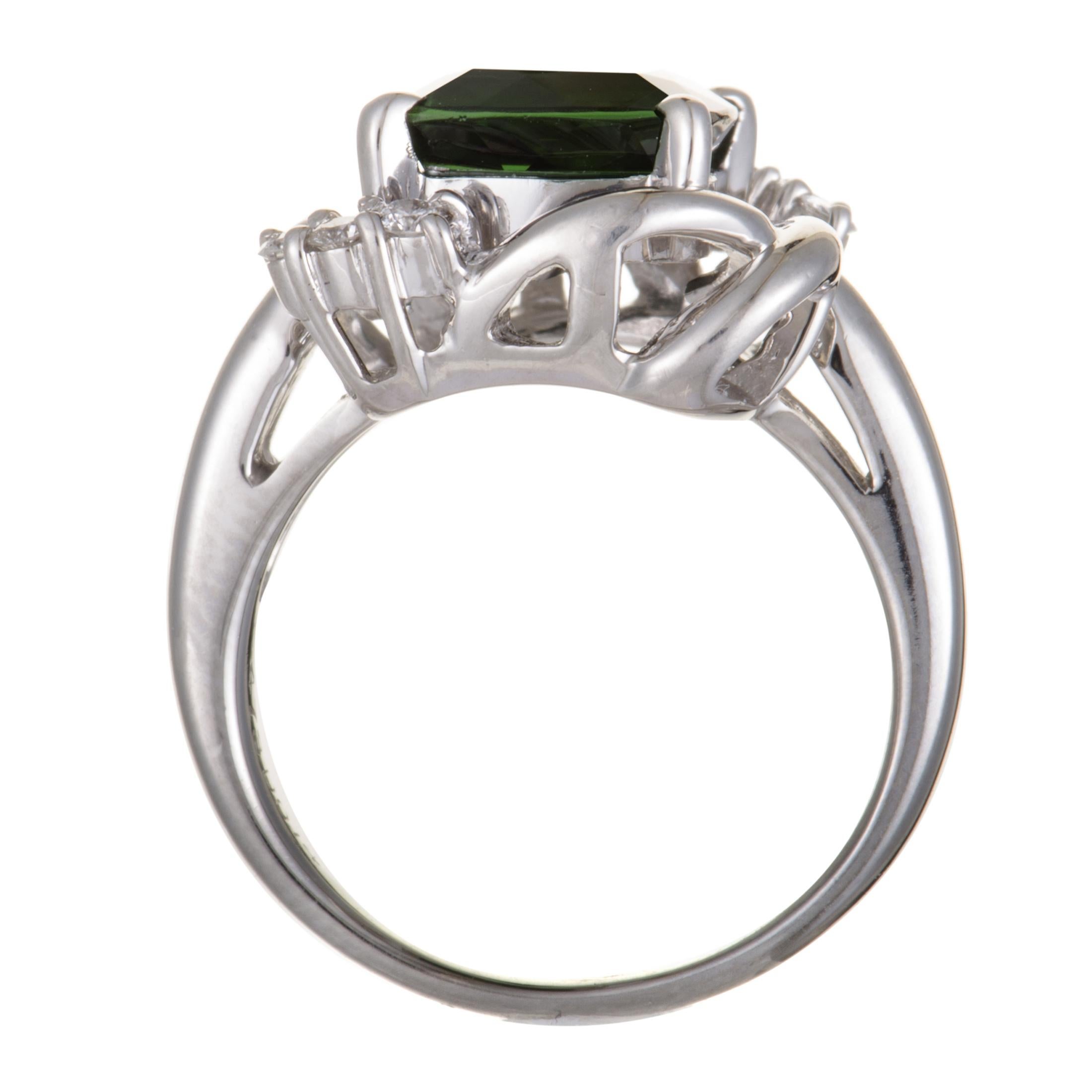 This aesthetically pleasing and extraordinarily designed ring epitomizes elegance, grace and sheer beauty. Exquisitely crafted in classy platinum, the stunning ring is adorned with 0.14ct of glamorous diamonds and a glamorous green tourmaline of
