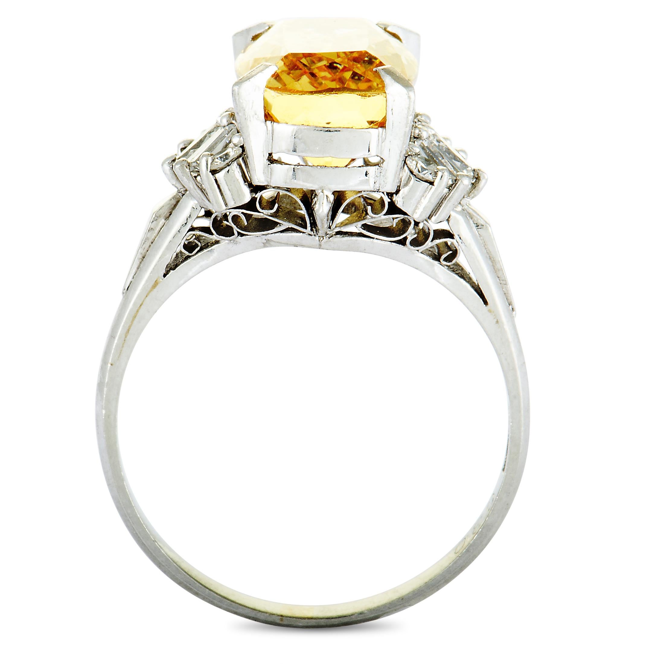 The stunning imperial topaz is the star of the show in this ravishing ring that is designed in a gorgeously refined fashion and expertly crafted from platinum. The imperial topaz weighs 5.18 carats and it is accentuated by resplendent diamonds that