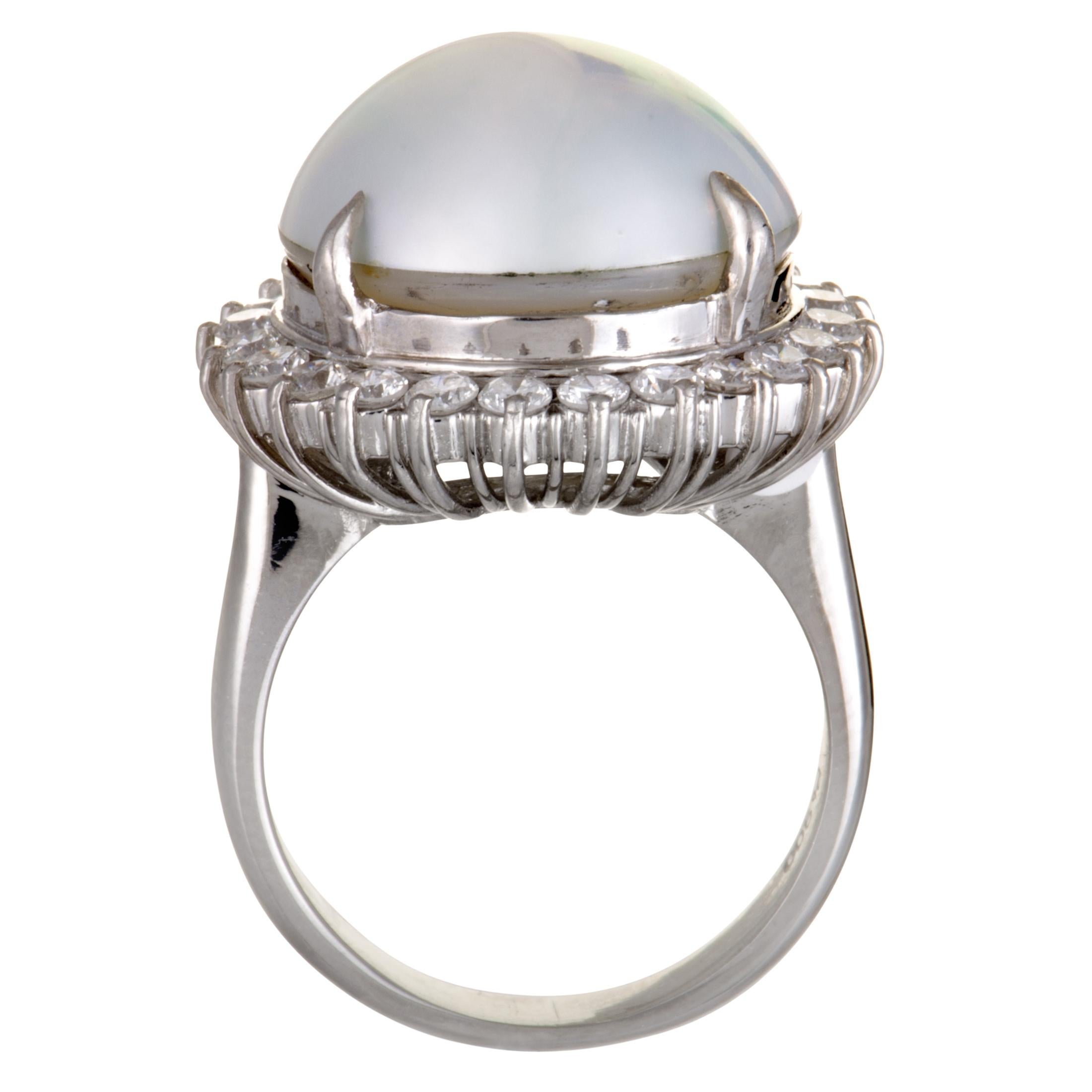 Framed in a stunningly luxurious fashion by gorgeously scintillating diamond stones, the sublime allure of the exceptional mabe pearl in this majestic ring is brought to a whole new level. The ring is made of platinum and boasts a total of 1.00