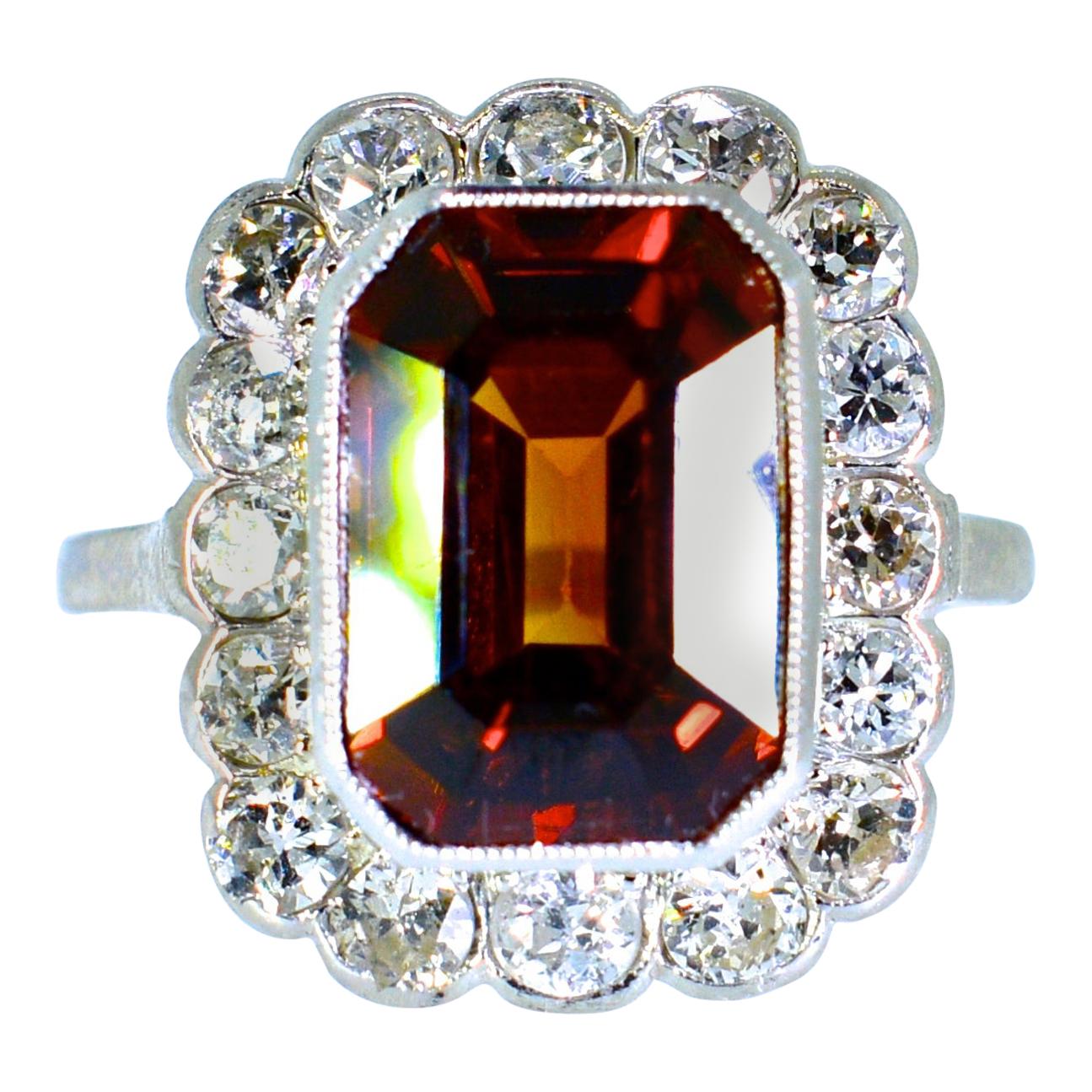  Fine natural Cognac Zircon.  The tawny color is very unusual.  It's chestnut like color has flashes of red which one rarely sees.  This stone weighs approximately 10 cts. and is surrounded by fine white old cut diamonds.  The diamonds weigh