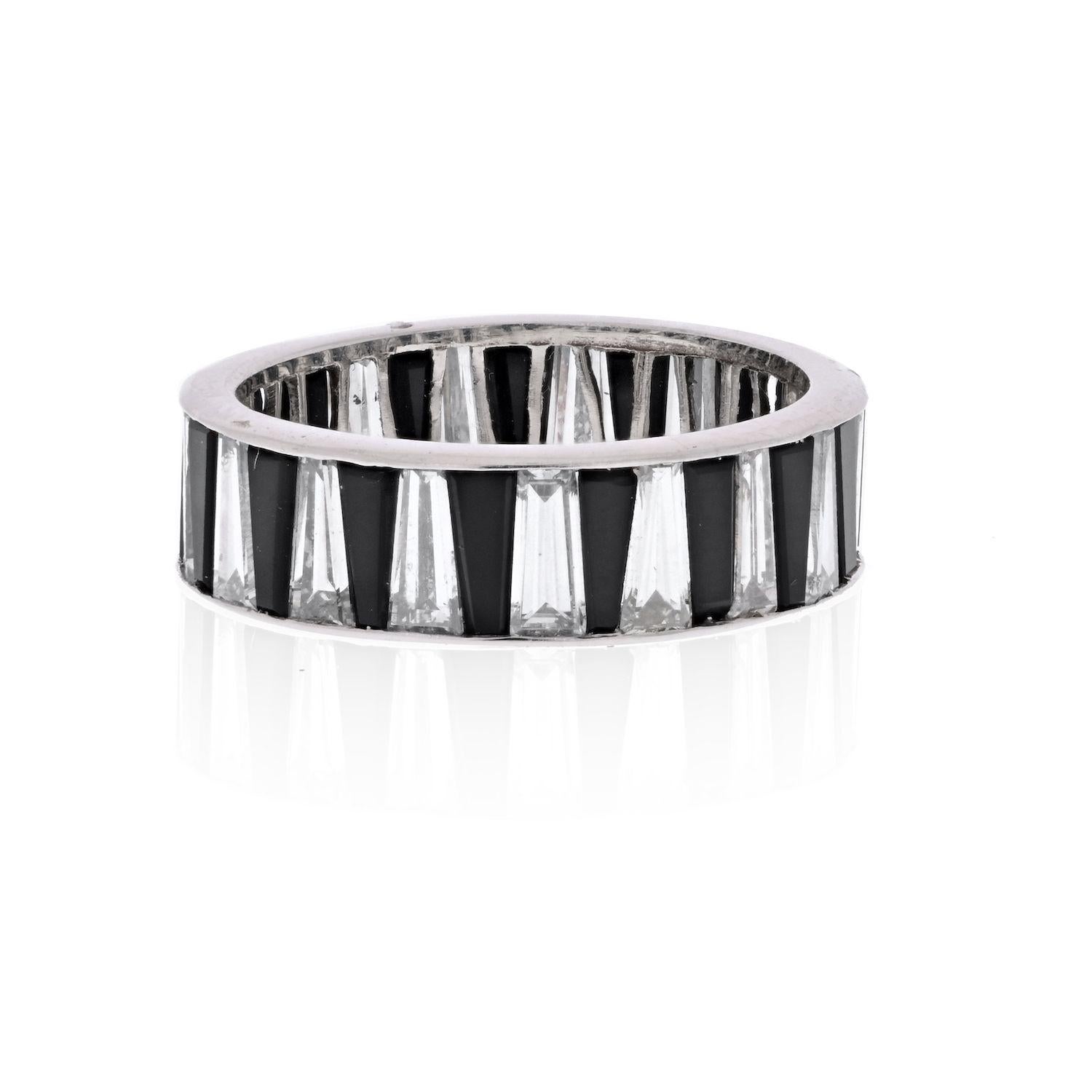 Very whimsical and special this diamond and onyx ring is designed as an eternity band with gems set full circle around. Each gem is cut as a tapered baguette and set in alternating order. Channel setting allows this ring to be worn as alone or