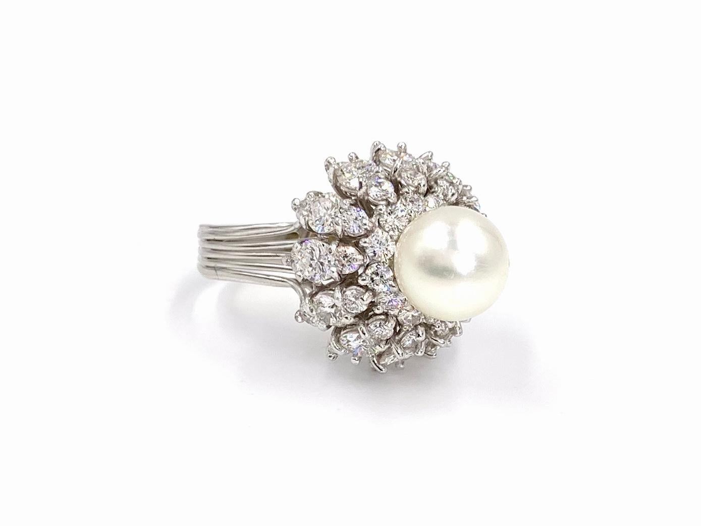 Circa 1940's this Edwardian inspired platinum cocktail ring features approximately 3 carats of round diamonds surrounding a 9-9.5mm round cultured pearl. This elegant ring is eye catching with a high profile and a generous amount of sparkle. Diamond