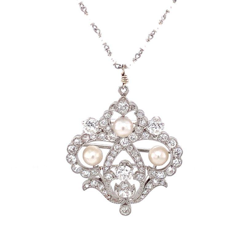 One platinum diamond and pearl pendant featuring 55 old European cut diamonds totaling 2.75 ct. Enhanced by 3 round white pearls measuring 5 millimeters in diameter on average. Suspended from a 18K white gold pearl chain with pearls measuring 2