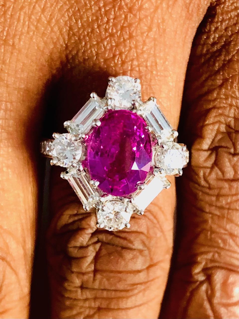 Platinum Fashionable Ring, set with a gorgeous color Pink Sapphire 4.08 carats surrounded by 16 Diamonds 2.27 carats.
The color of this clean Pink Sapphires is the most sweet and desirable.

We design and manufacture our jewelry in our workshop,