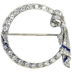 Platinum Diamond and Sapphire Art Deco Circle Ribbon Brooch