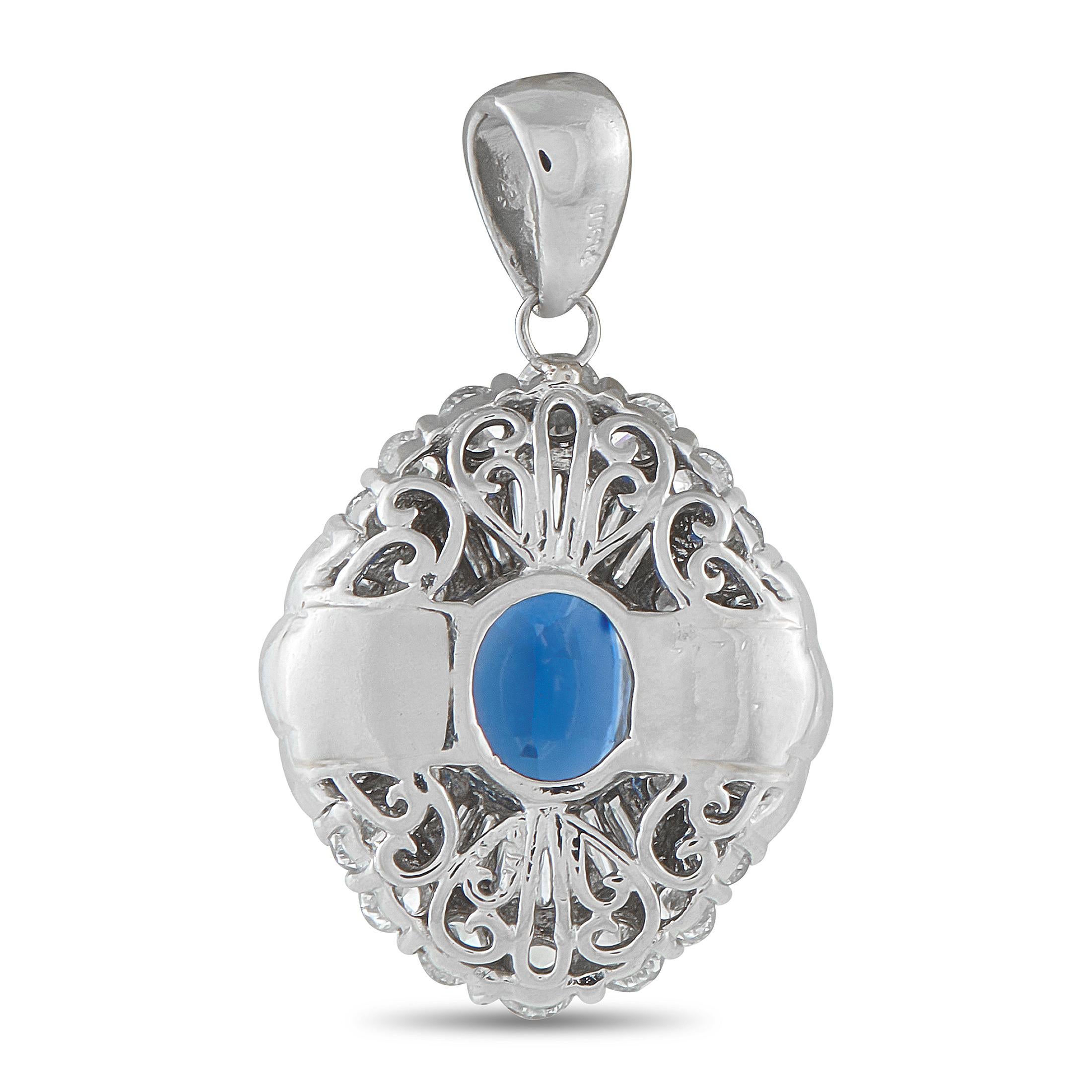 An pendant that catches attention with its distinctly graceful presence. It holds an oval blue sapphire held on four elegant prongs, and framed by two layers of diamonds that create a brilliant setting reminiscent of a ballerina's multi-layered