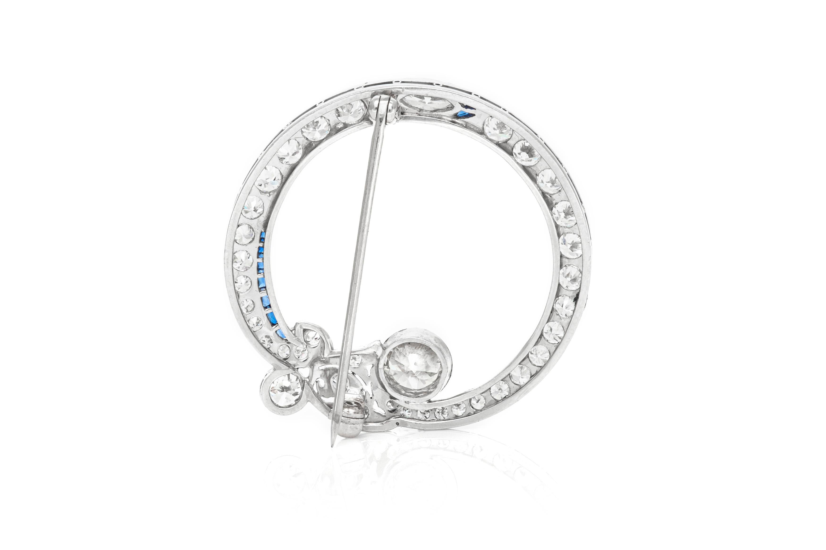 The brooch is finely crafted in platinum with diamonds weighing total of 3.25 carat and sapphire.