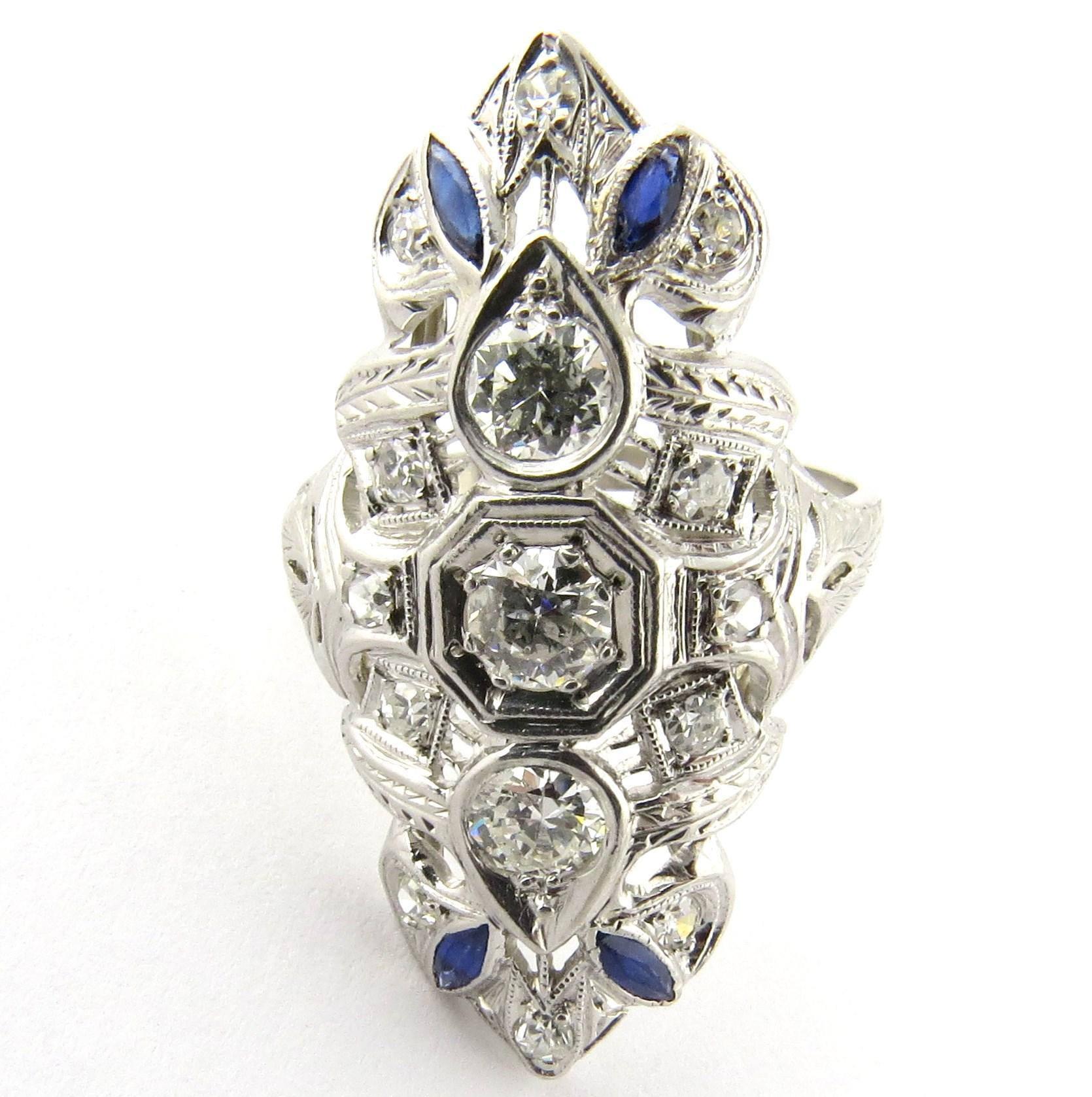 Vintage Platinum Diamond and Sapphire Dinner Ring. 

Gorgeous example of vintage filigree diamond and sapphire splendor. 

Size 6 1/4 Measures: 1 1/4