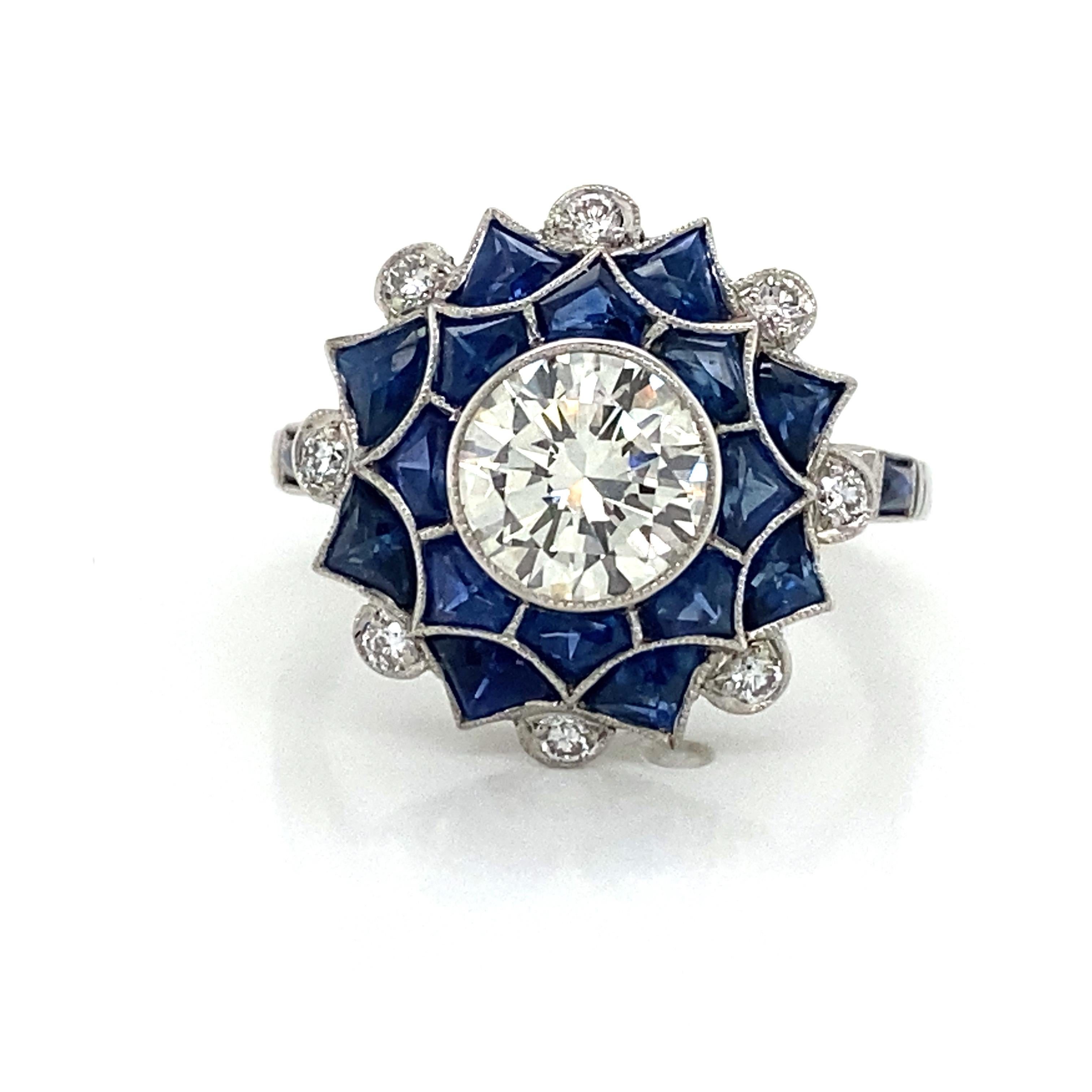 Diamond and Sapphire Ring in Platinum.  Round Brilliant Cut Diamonds weighing 1.75 carat total weight, including 1.50 carat center, J-K in color and VS in clarity and (16) Sapphires weighing 2.40 carat total weight are expertly set.  The Ring