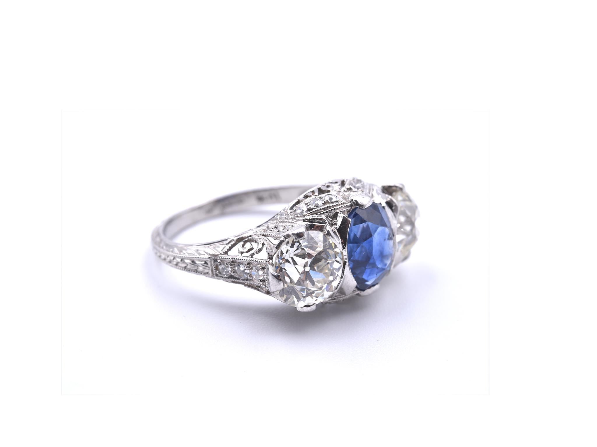 Designer: custom design
Material: platinum
Sapphire: 1 oval faceted cut = 2.25ct
Diamonds:  1 European cut = 1.20ct
Diamonds: 1 European cut= 1.10ct
Color: K
Clarity: VS
Ring Size: 5 ½ (please allow two additional shipping days for sizing