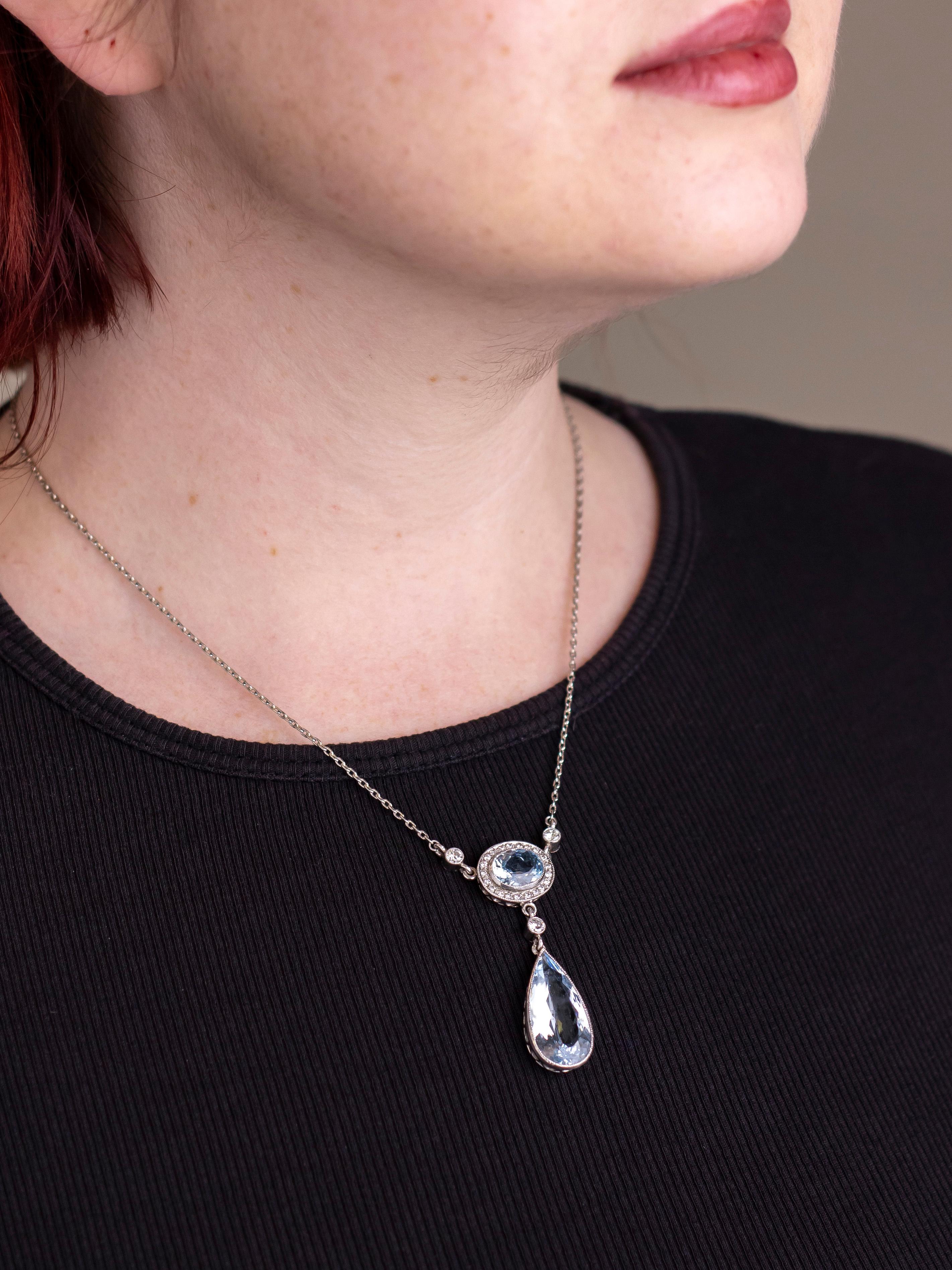 This aquamarine necklace whilst not of any great age has been crafted from quality stones and entirely set in platinum and 18 karat white gold. The necklace centres on two aquamarines, one oval cut, the other pear cut, each a medium light blue with