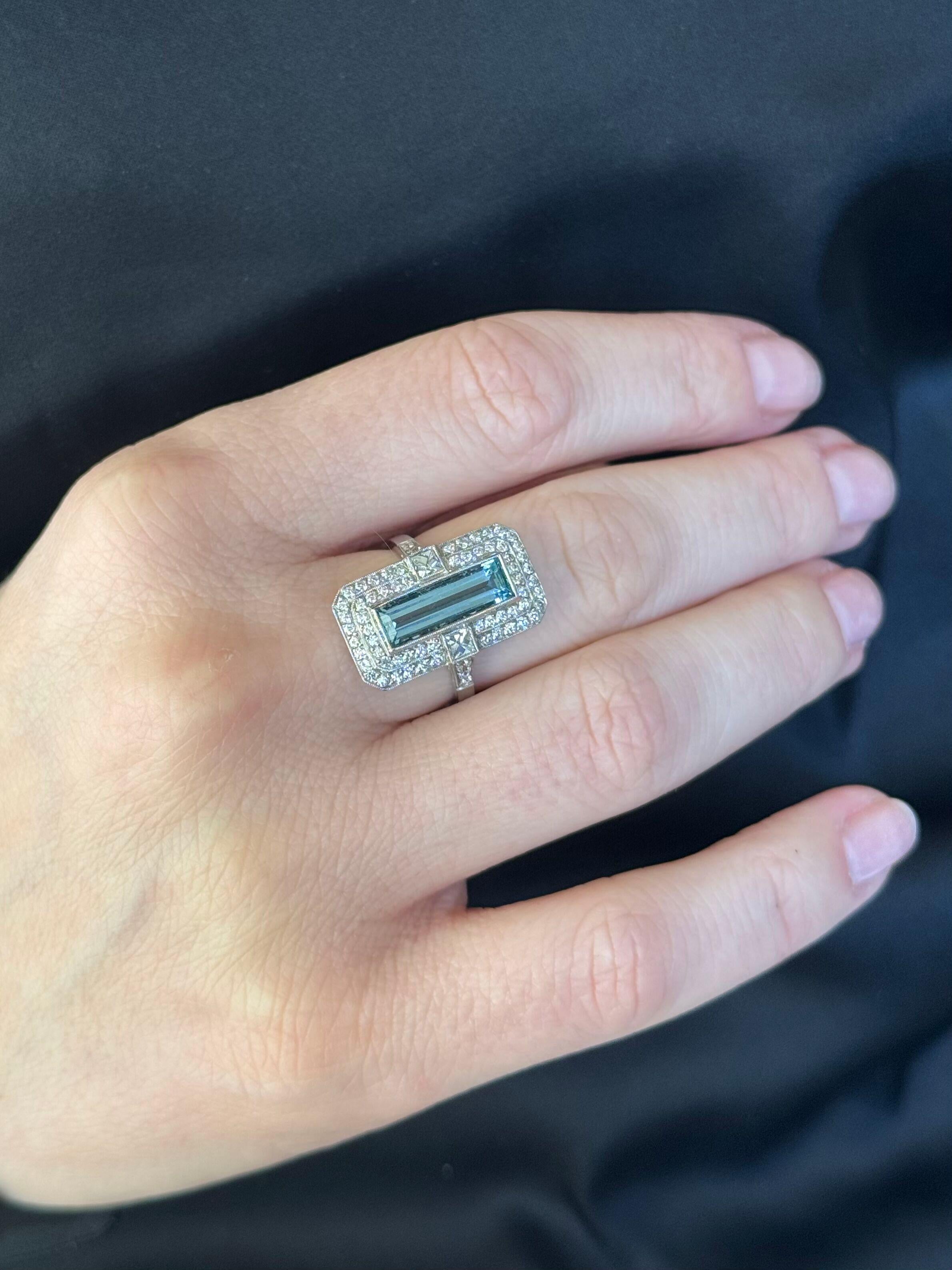 Platinum ring, set with center aquamarine approx. 1.80ct (measures approx. 14.3 x 4.9 x 3.7mm), surrounded with approx. 0.80ctw in G/VS diamonds. 
Ring size 7.5, top is 22mm x 14mm.
Marked Plat.
Weight - 7.7 grams. 