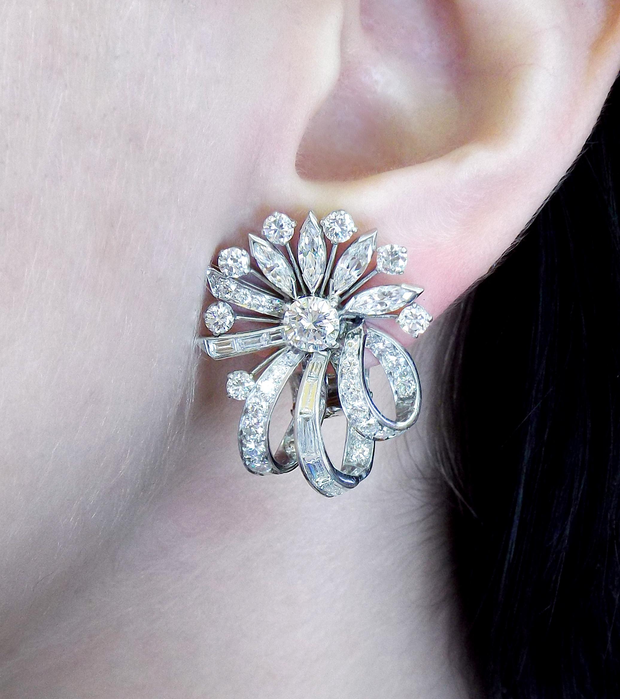 The earrings feature round brilliant-cut diamonds weighing a total of 1.00 carat, enhanced by full-cut diamonds weighing a total of 2.65 carats, accented by marquise-cut diamonds weighing a total of 1.10 carats, complemented by baguette-cut diamonds