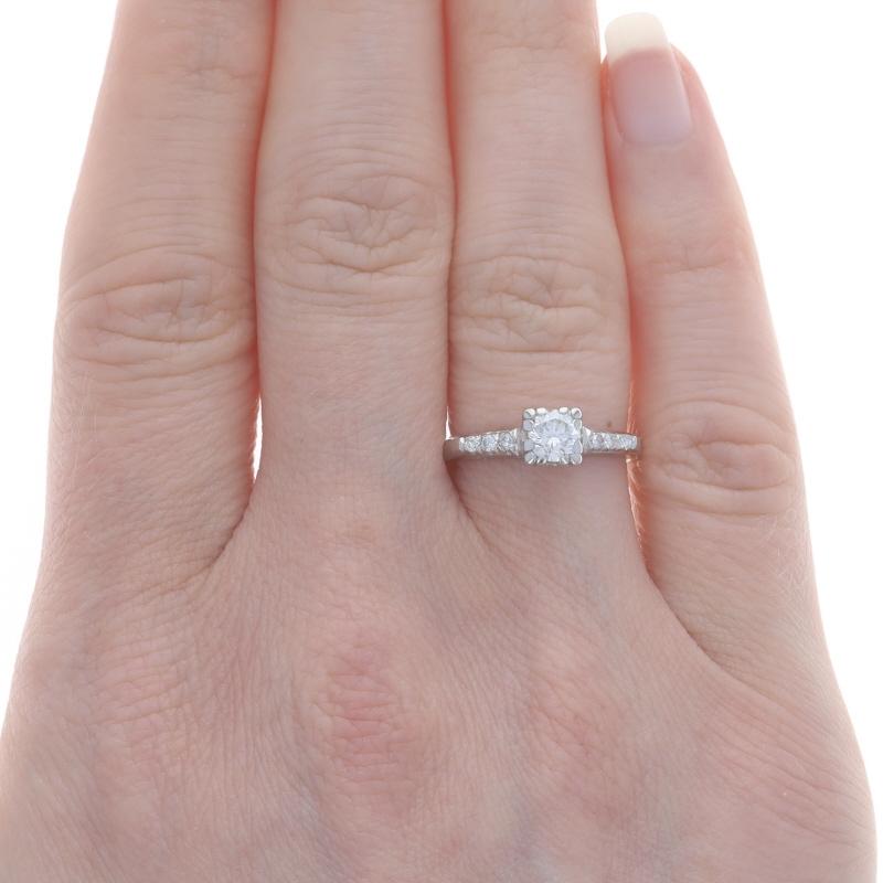 Size: 5 1/2
Sizing Fee: Up 2 1/2 sizes for $50 or Down 1/2 a size for $50

Era: Art Deco
Date: 1930s - 1940s

Metal Content: 90% Platinum

Stone Information

Natural Diamond
Carat(s): .40ct
Cut: Round Brilliant
Color: G
Clarity: VS1

Natural
