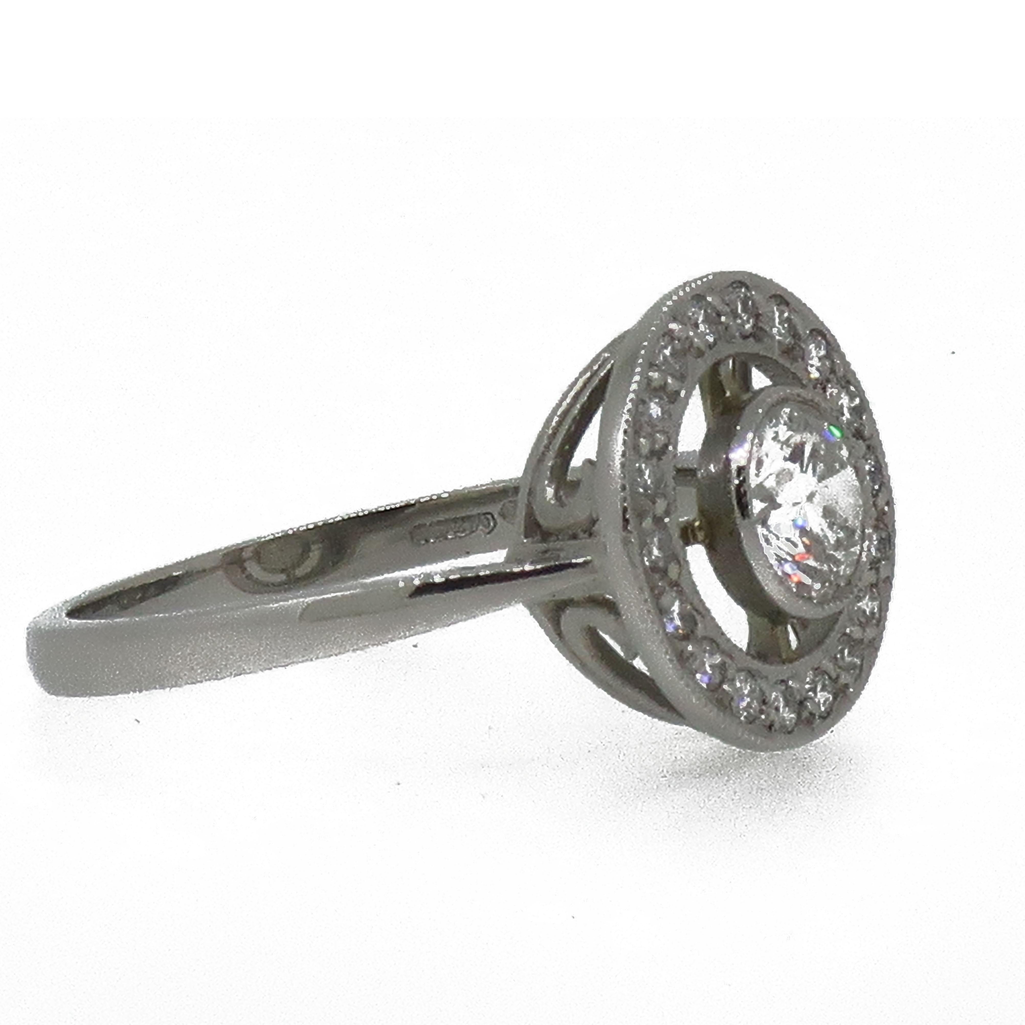 Platinum Diamond Art Deco Style Target Cluster Ring

Antique style target ring consisiting of one round brilliant cut diamond to the centre of the ring weighing 0.50ct, open frame work then surrounded by a boarder of brilliant cut diamond, weighing
