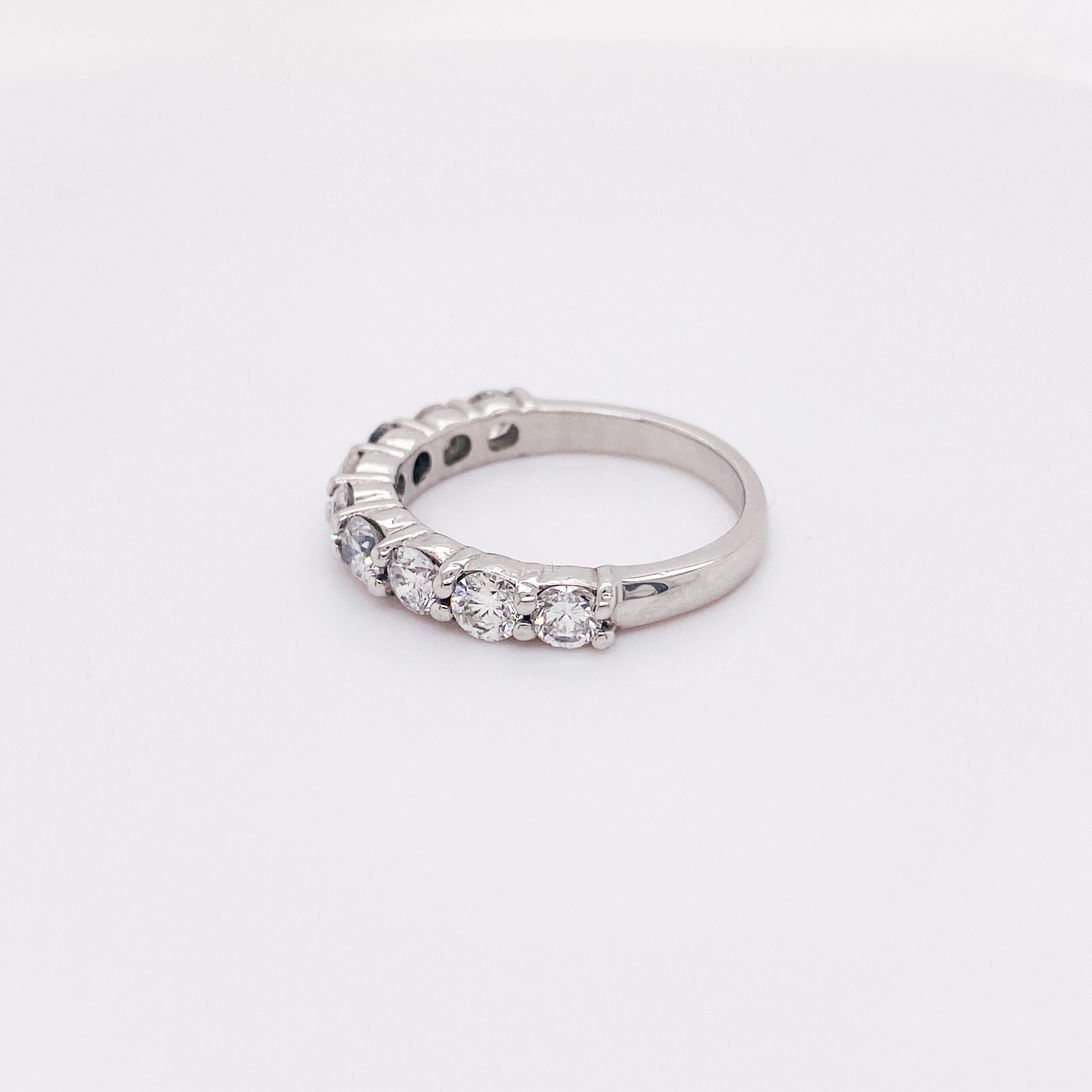 Rock your diamonds and stack up a beautiful set of rings with this gorgeous strong and sturdy platinum ring. Nine diamonds sit halfway around the ring with minimalist shared prongs. At 3.3 mm wide, this band will stack beautifully with your other