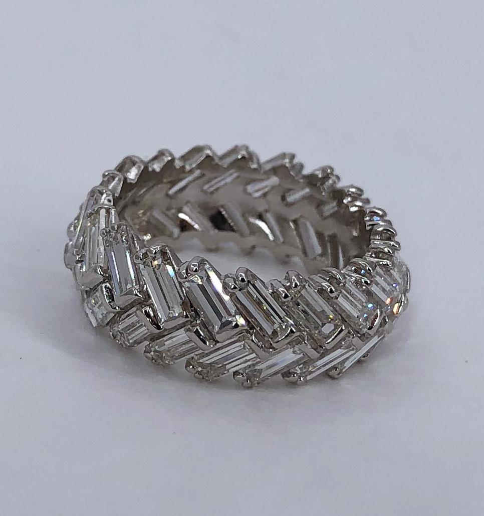 An unusual version of the traditional diamond band, this ring is set with 42 baguette cut diamonds, arranged in a 