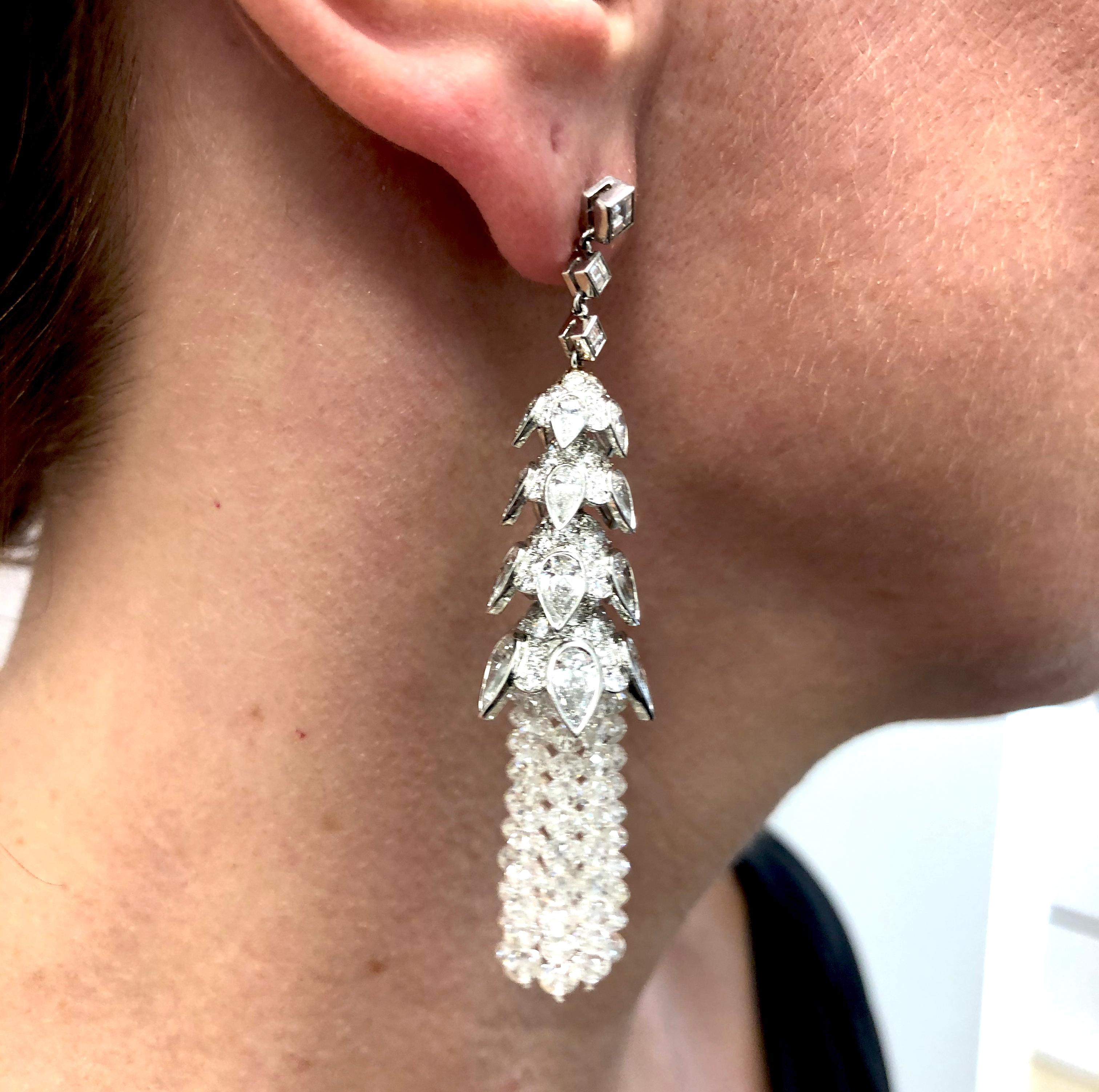 Contemporary Diamond Tassel Earrings in Platinum.

A contemporary pair of earrings with four tiers of graduated platinum crowns and a cascading fringe of scintillating diamond beads. Each crown is set with white pear-shaped and round brilliant