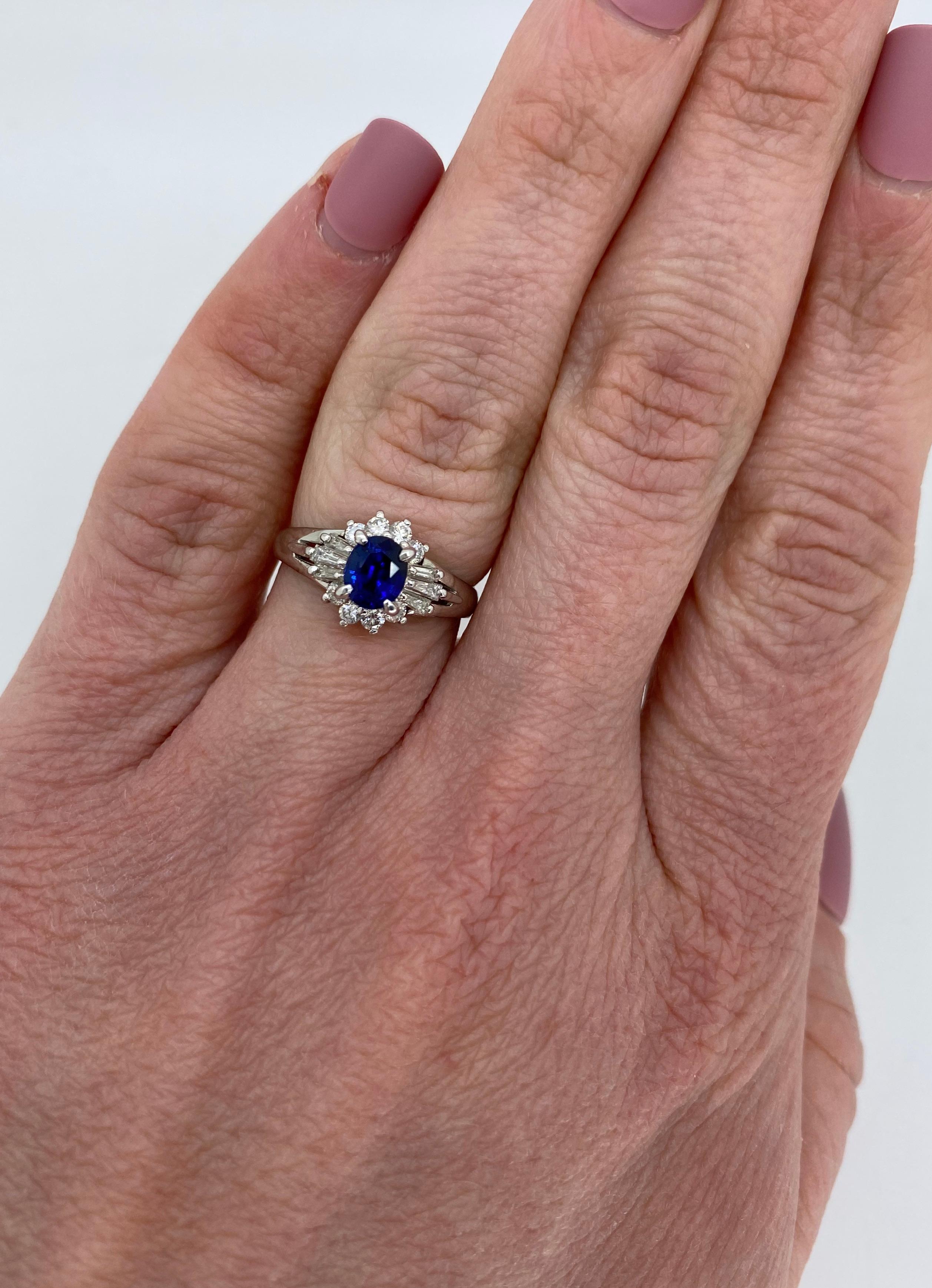 Sapphire and diamond ballerina style ring crafted in platinum.

Gemstone: Sapphire & Diamonds
Gemstone Carat Weight:  Approximately .77CT Blue Sapphire
Diamond Carat Weight:  Approximately .35CTW
Diamond Cut: Round Brilliant Cut and Tapered Baguette