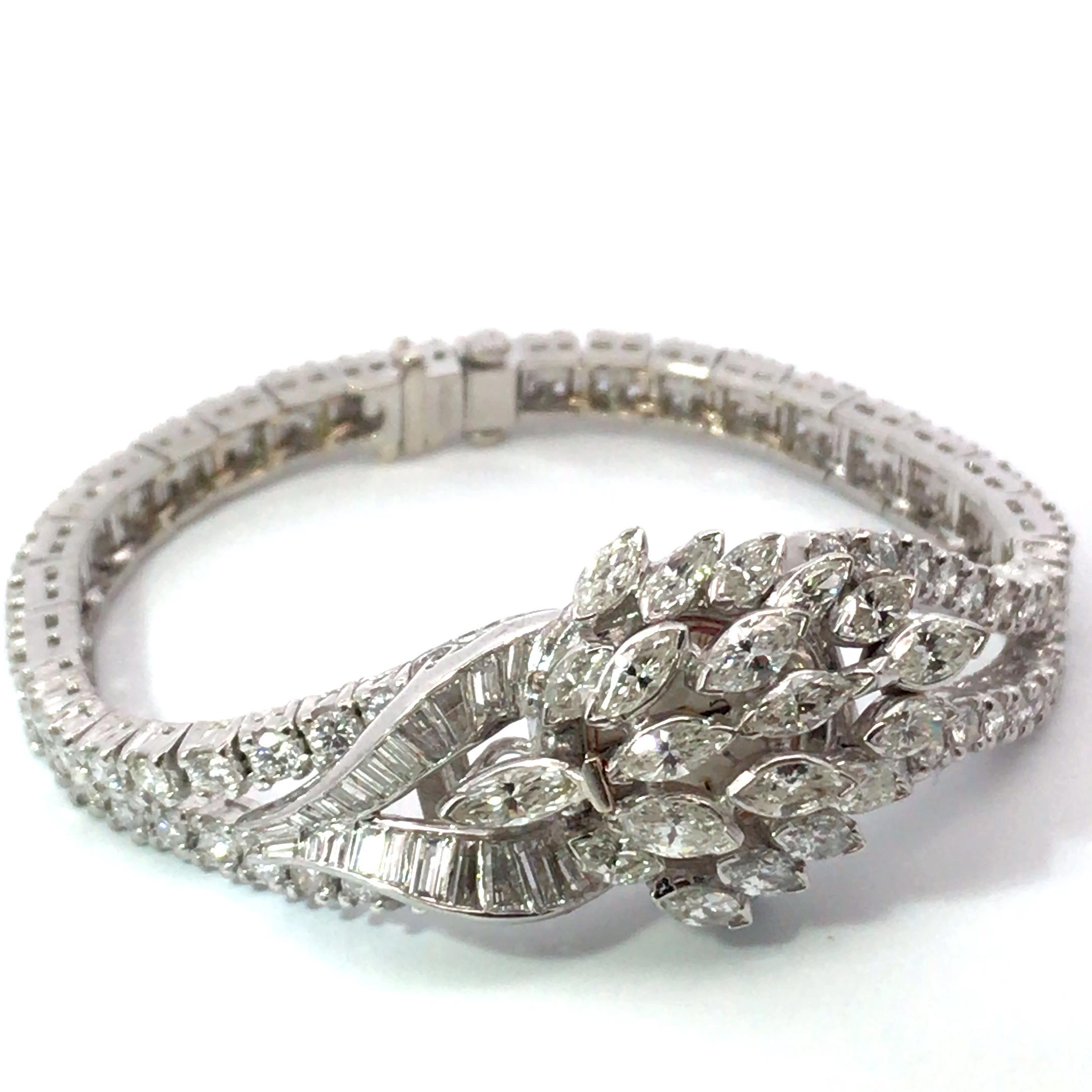 Platinum Diamond Bracelet Watch
39.9 grams
92 Round Brilliant cut Diamonds weighing approximately 6.44 carats.
20 Marquise cut Diamonds weighing approximately 5.00 carats.
22 Baguette cut Diamonds weighing approximately 1.32 carat
all weighing