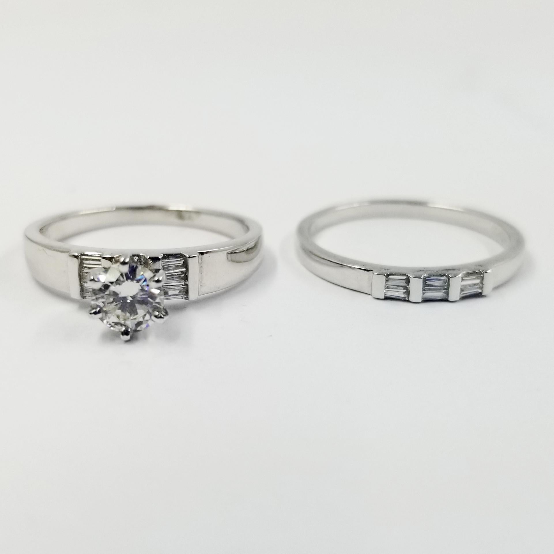 Platinum bridal set including an engagement ring and a wedding band. The engagement ring features a round brilliant cut diamond weighing exactly 0.40 carat that is GIA graded as VS1 clarity & J color (report #2101584328) set in a 6 prong setting.