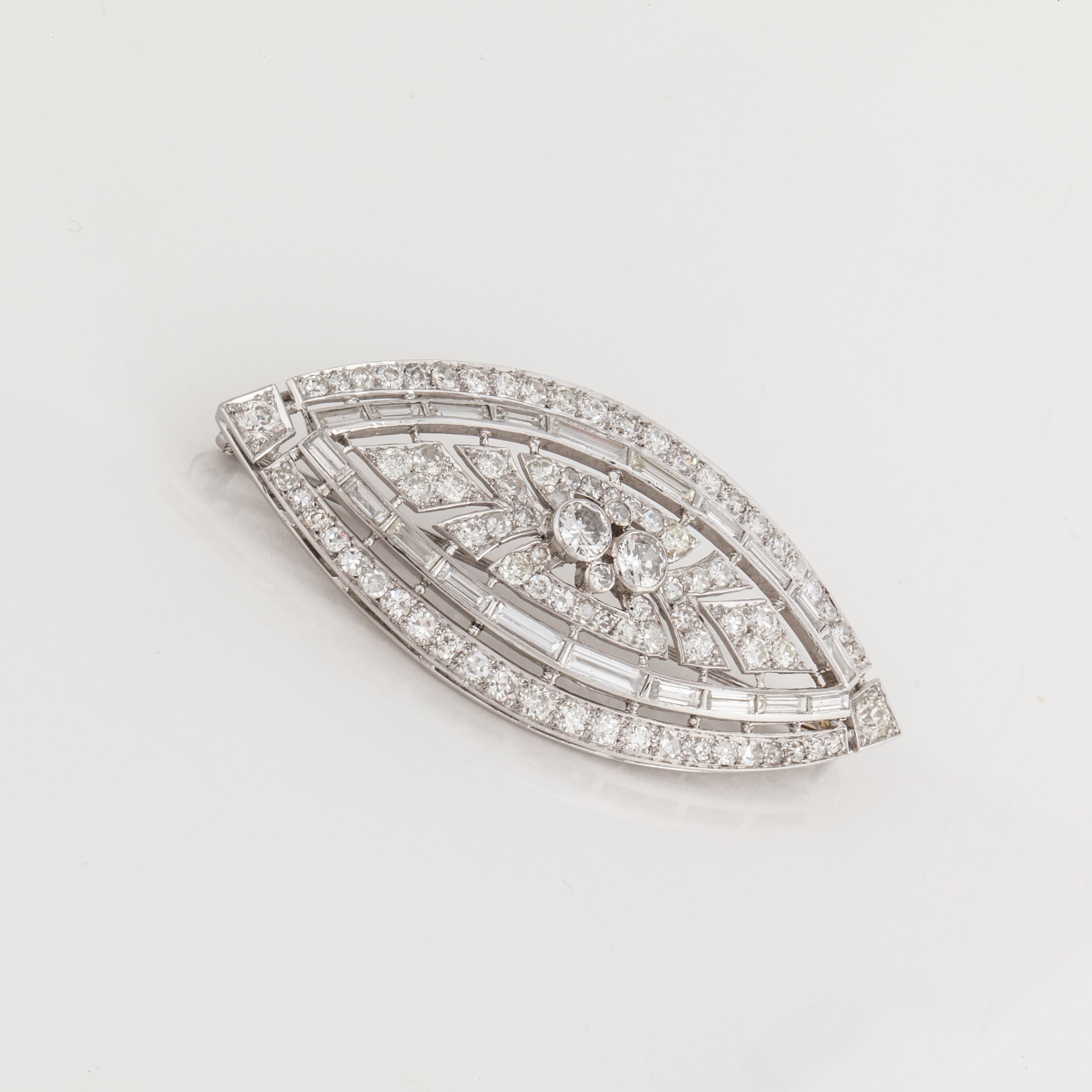 Platinum marquise shaped diamond brooch with round and baguette diamonds that total 5.42 carats; H-K color and VS1-SI2 clarity.  The brooch measures 2 3/8 inches long and 1 1/8 inches wide.  Clasp has a trombone closure. Circa 1930's-1940's.
