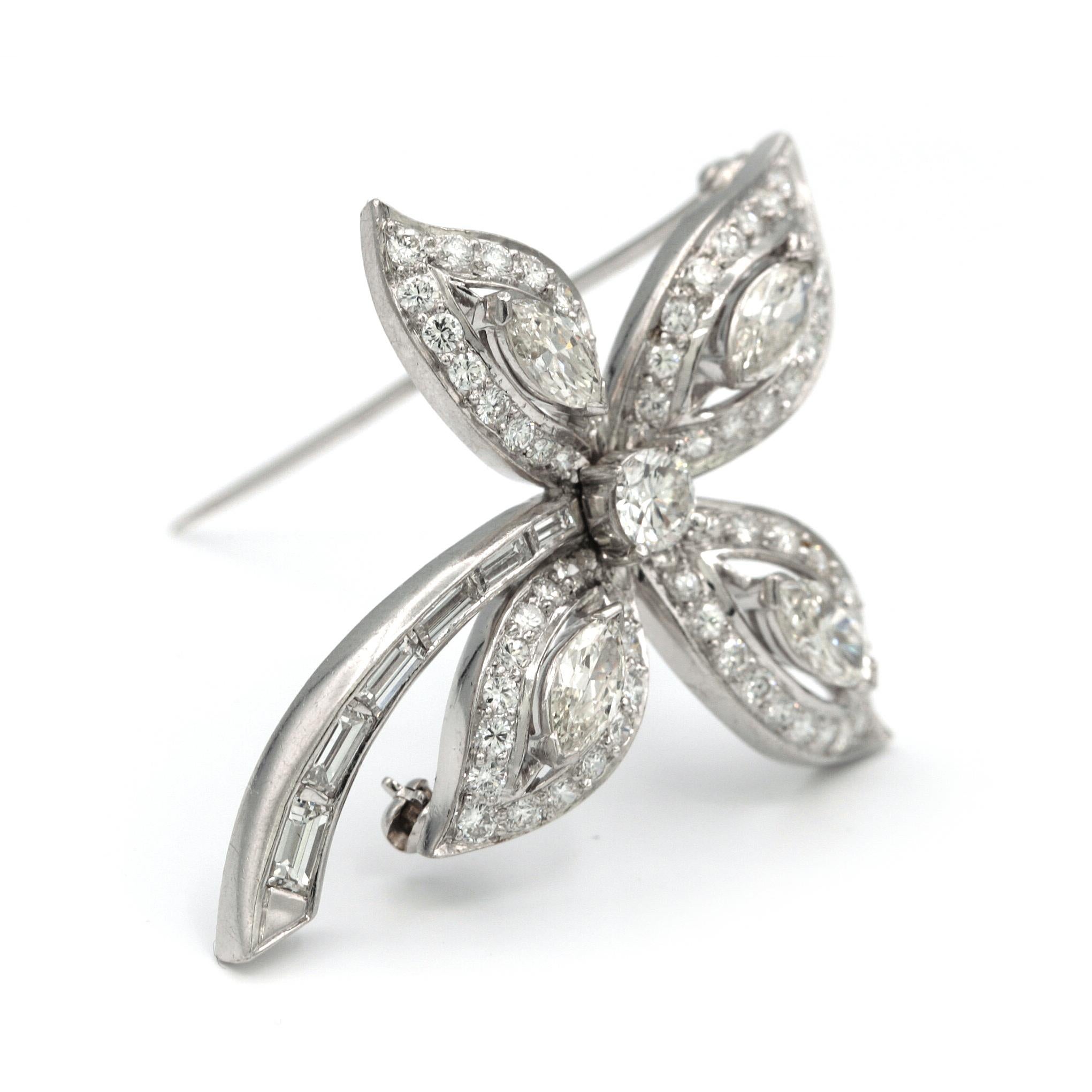 Platinum Flower shaped brooch, with center round diamond Set with 4.41 carats of white diamonds, including 4 marquise shaped stones, 1 round shape, 6 rectangular cut stones, along with 61 pave stones.
Has a length of 4.3cm and a width of 4cm
Weights