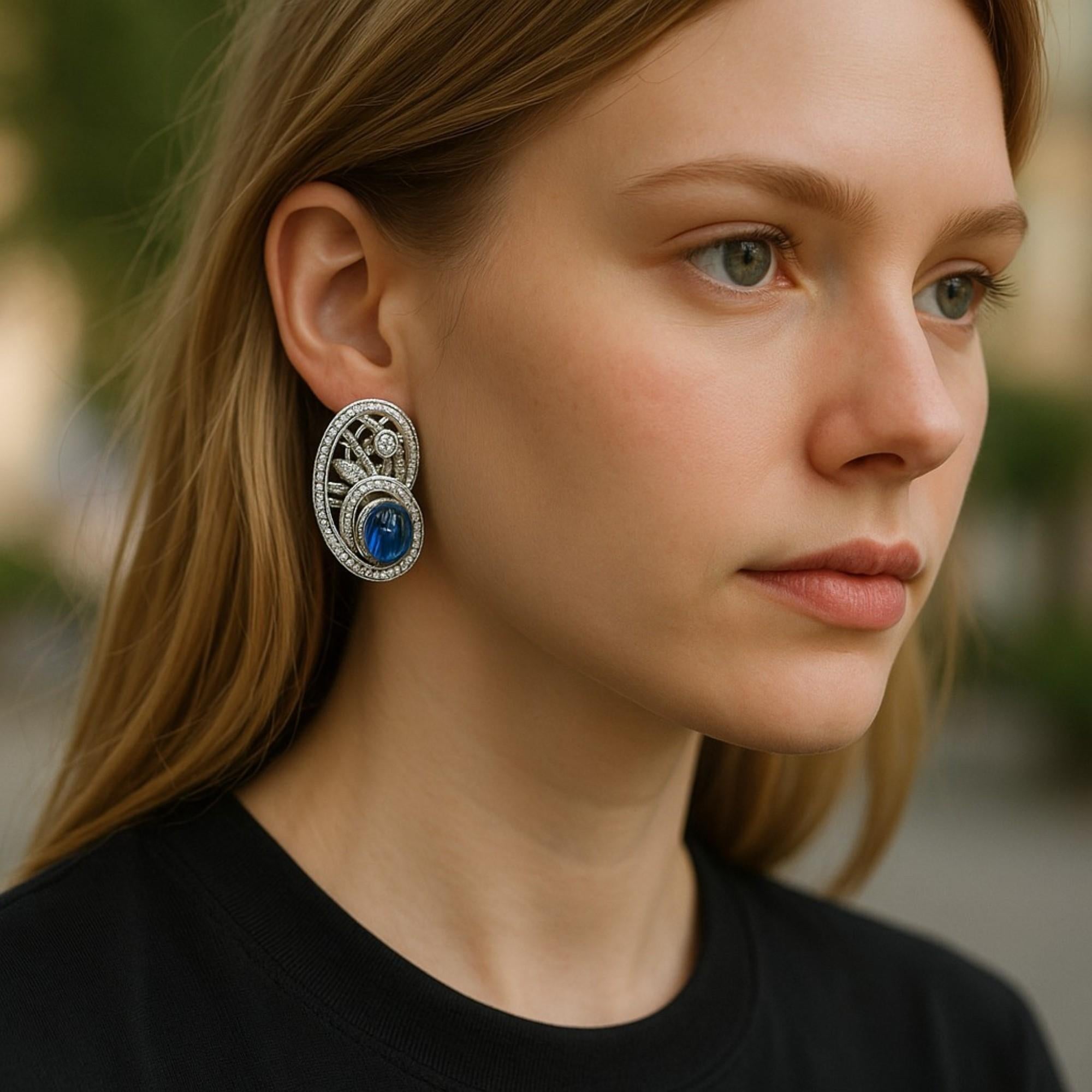 An Exquisite Fusion of Color and Brilliance
Elevate your jewelry collection with these vintage platinum clip-on earrings, each showcasing a Ceylon cabochon sapphire of exceptional allure and surrounded by a cascade of pavé-set diamonds. Crafted in