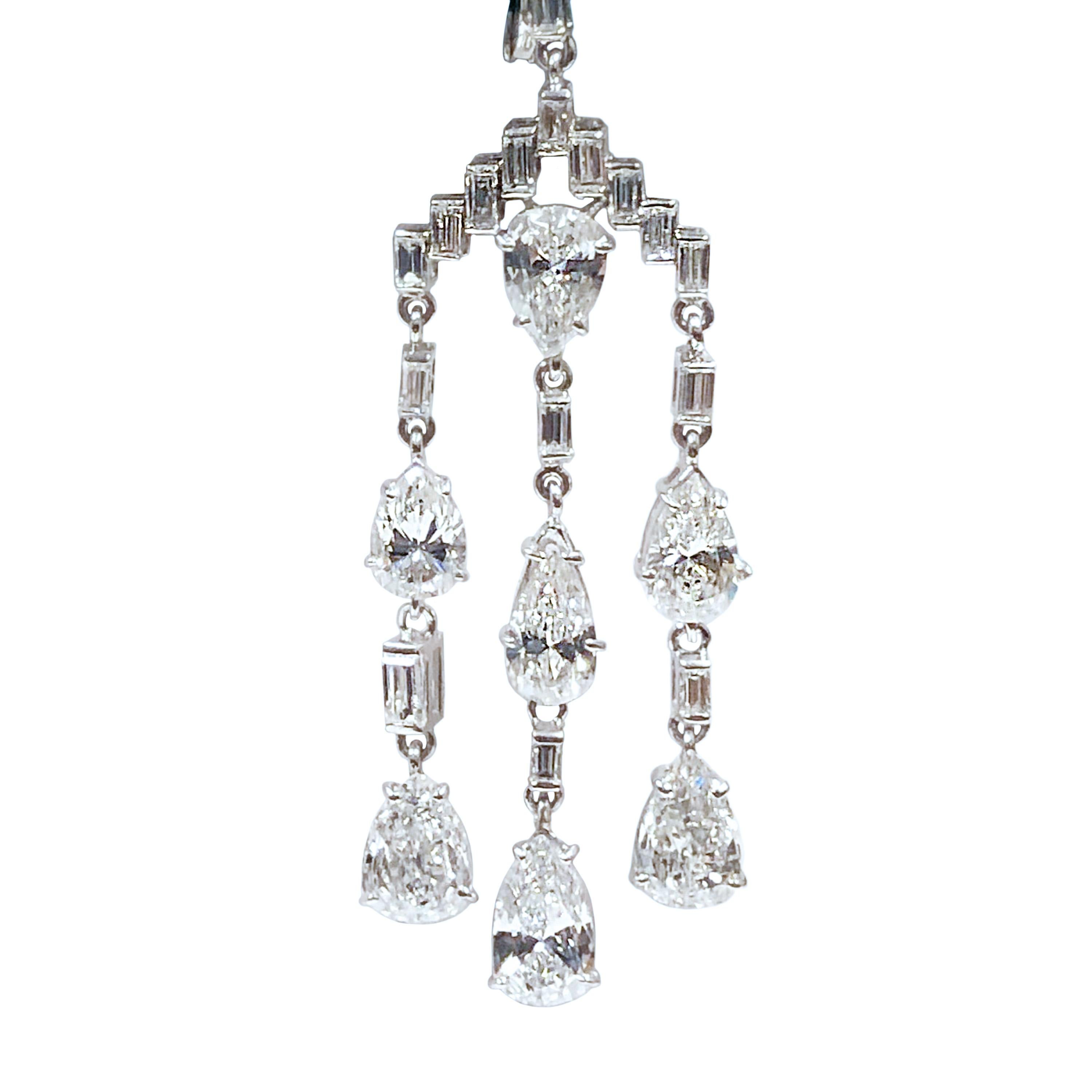 Phenomenal Platinum Earrings in a late Edwardian, Art Deco style, completely hand made and set with Pear shape and Baguette Diamonds totaling 9 to 9.50 Carats and grading as G in color and VS in Clarity. Measuring 2 inches in length and 5/8 inch