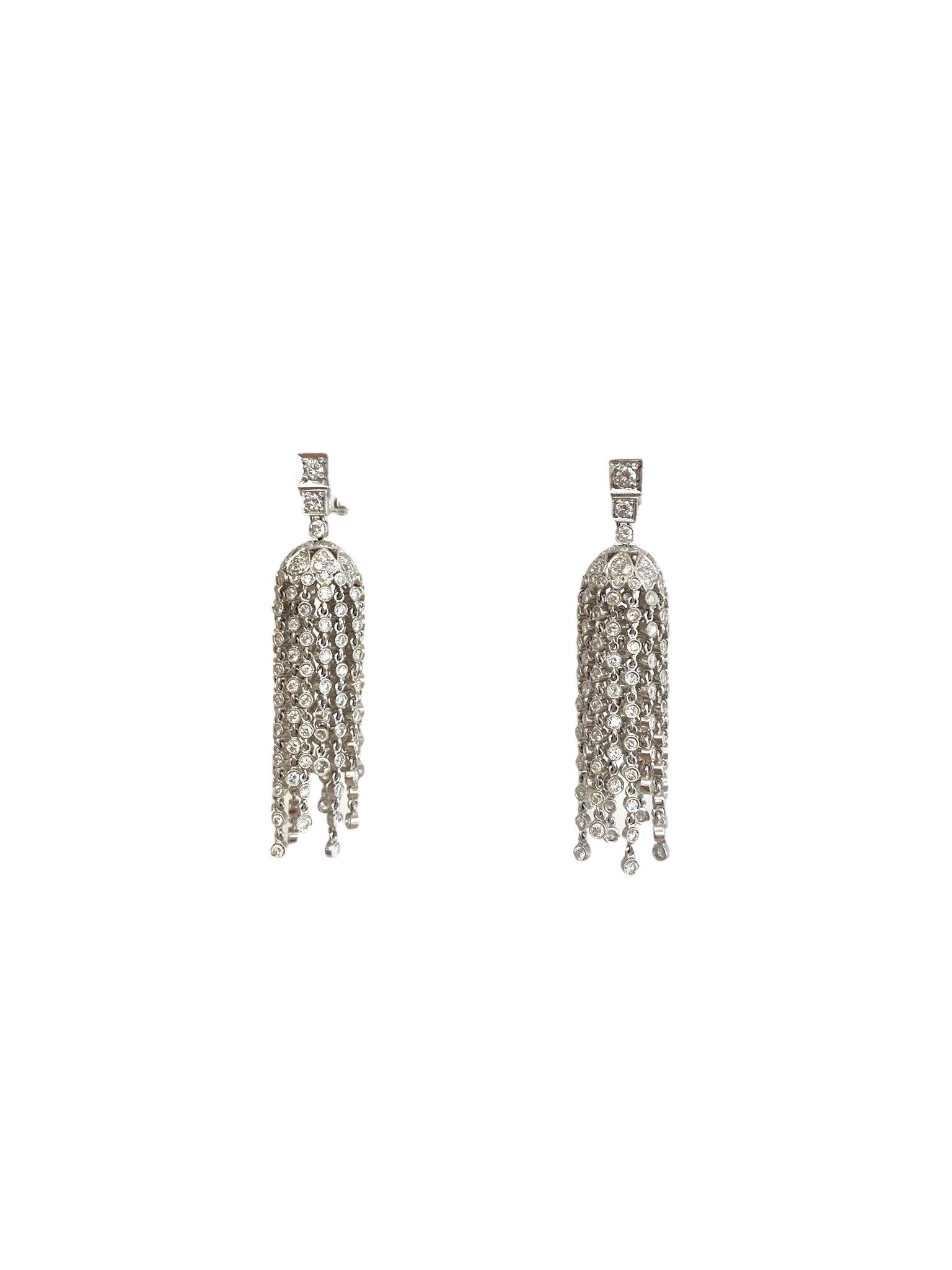These elegant chandelier-style drop earrings are crafted in platinum and shimmer with a dazzling array of diamonds totaling approximately 8.93 carats. The upper portion features brilliant-cut diamonds totaling 0.68 carats, while the cascading