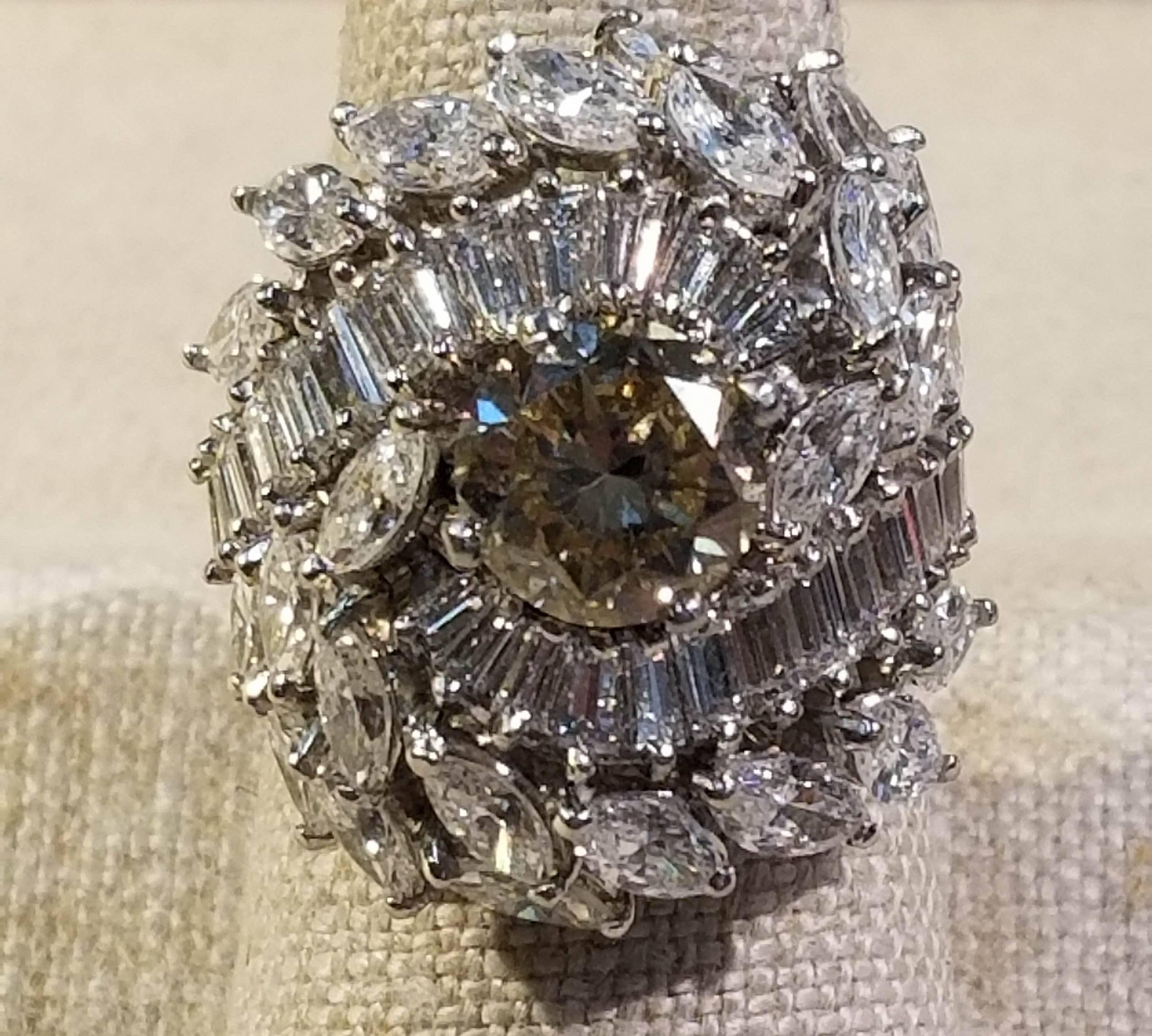 Platinum Diamond Cluster Ring. 
Platinum mounting is set with a center Diamond that is Light Brown in color with an SI clarity and is GIA cert. The center diamond is 2.03 cts. The surrounding 24 Marquise Diamonds and 28 Tapered Baguette Diamonds are